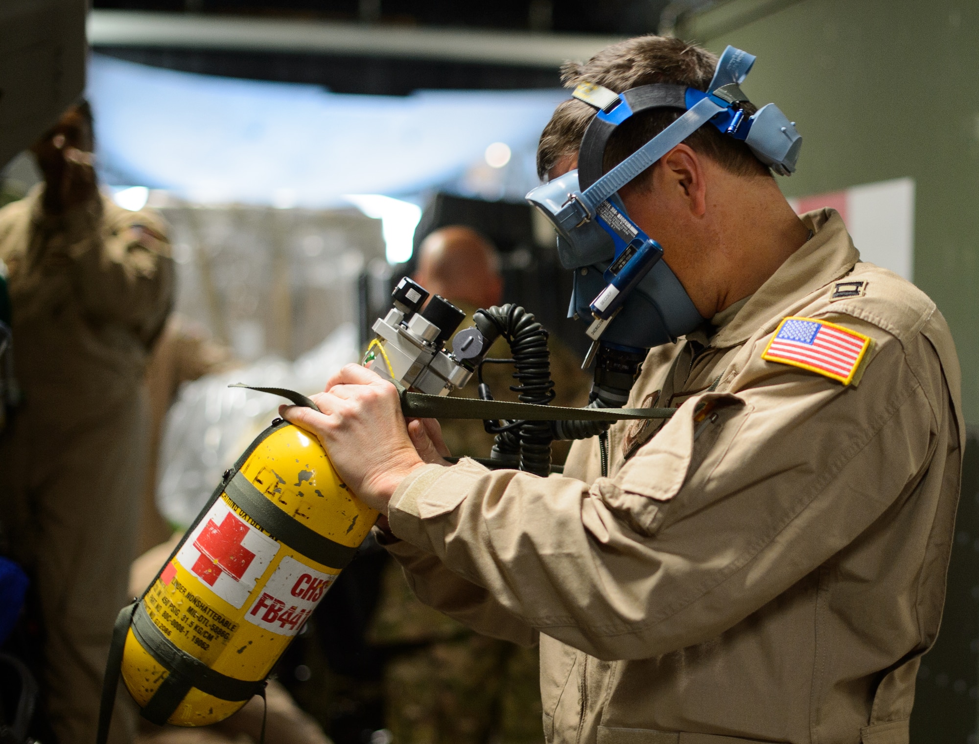 Capt. Benjamin Schultze, 10th Expeditionary Aeromedical Evacuation Flight nurse, adjusts his oxygen mask Nov. 10, 2015, at Ramstein Air Base, Germany. After configuring the inside of the C-17 Globemaster III into a flying ambulance, the Airmen test their equipment to ensure they can provide the best possible treatment while flying thousands of feet in the air. The 10th EAEF is a mixture of active-duty, reserve and guard Airmen deployed to Ramstein, constantly flying to war zones to retrieve patients needing higher levels of medical care. (U.S. Air Force photo/Staff Sgt. Armando A. Schwier-Morales)