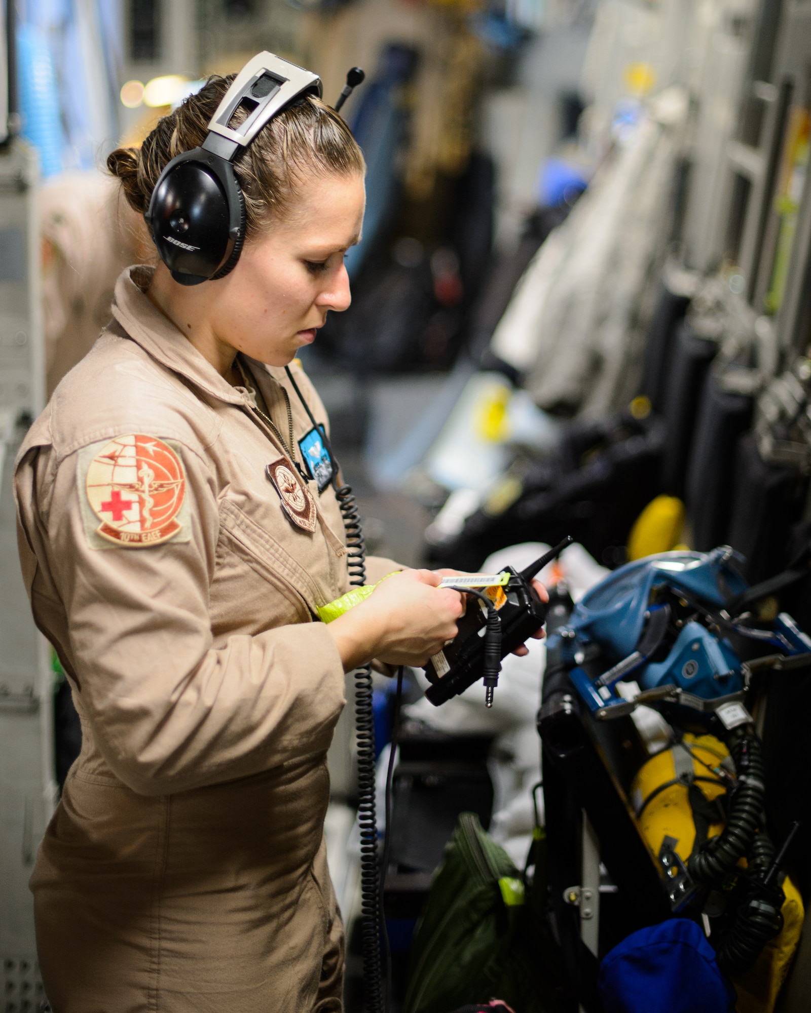 Senior Airman Beverly Spencer, 10th Expeditionary Aeromedical Evacuation Flight technician, checks a radio’s service Nov. 10, 2015, at Ramstein Air Base, Germany. After configuring the inside of the C-17 Globemaster III into a flying ambulance, the Airmen test their equipment to ensure they can provide the best possible treatment while flying thousands of feet in the air. The 10th EAEF is a mixture of active-duty, reserve and guard Airmen deployed to Ramstein, constantly flying to war zones to retrieve patients needing higher levels of medical care. (U.S. Air Force photo/Staff Sgt. Armando A. Schwier-Morales)