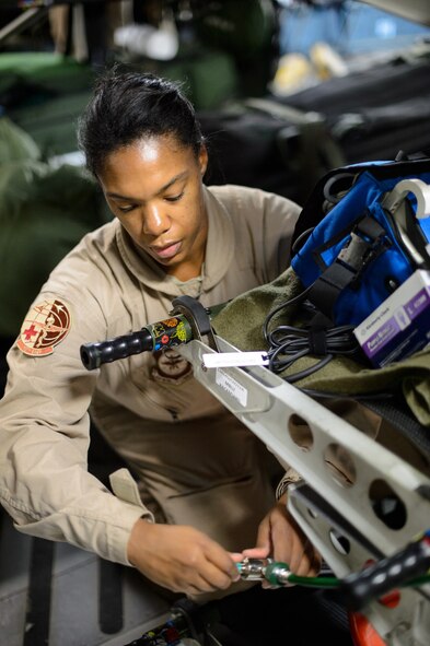Master Sgt. Natalia Stockhausen, 10th Expeditionary Aeromedical Evacuation Flight technician, connects medical equipment to a C-17 Globemaster III’s systems Nov. 10, 2015, at Ramstein Air Base, Germany. After configuring the inside of the C-17 Globemaster III into a flying ambulance, the Airmen test their equipment to ensure they can provide the best possible treatment while flying thousands of feet in the air. The 10th EAEF is a mixture of active-duty, reserve and guard Airmen deployed to Ramstein, constantly flying to war zones to retrieve patients needing higher levels of medical care. (U.S. Air Force photo/Staff Sgt. Armando A. Schwier-Morales)