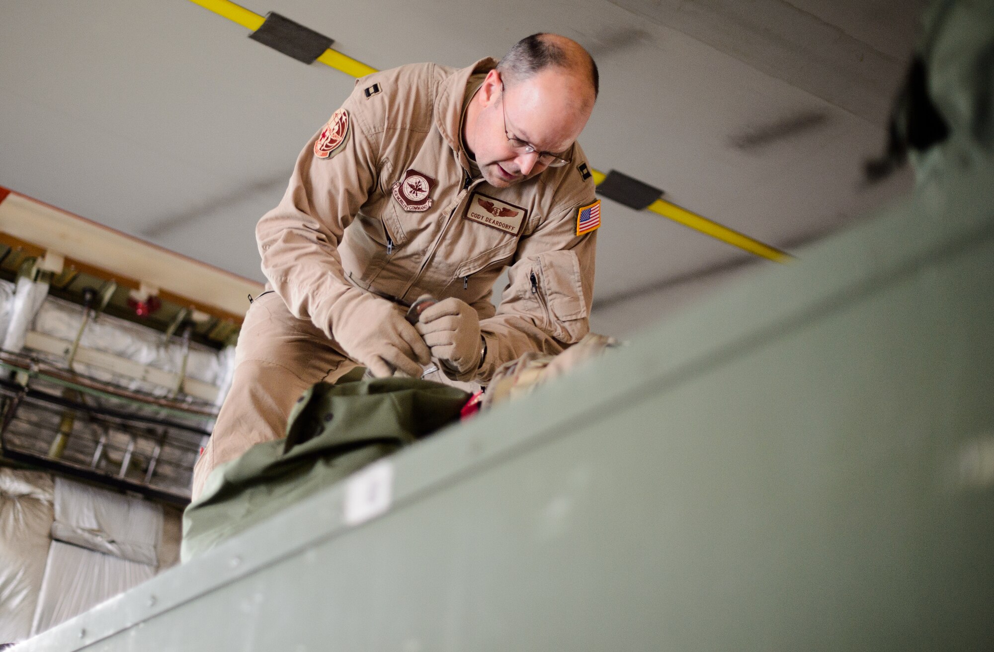 Capt. Cody Deardorff, 10th Expeditionary Aeromedical Evacuation Flight nurse, ties down bags inside of a C-17 Globemaster III Nov. 10, 2015, at Ramstein Air Base, Germany. Deardorff and several other medical personnel helped to save more than 2,500 lives through aeromedical evacuation this year. (U.S. Air Force photo/Staff Sgt. Armando A. Schwier-Morales)