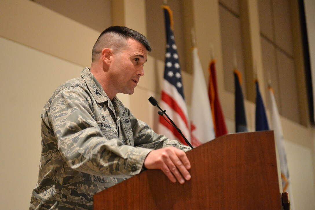 Col. John Wagner, 460th Space Wing commander, speaks to Team Buckley members during the Veterans Day ceremony at the Leadership Development Center Nov. 13, 2015, on Buckley Air Force Base, Colo. The ceremony included a guest speaker and a flag-folding ceremony performed by the Aerospace Data Facility-Colorado Joint Color Guard. (U.S. Air Force photo by Staff Sgt. Darren Scott/Released)