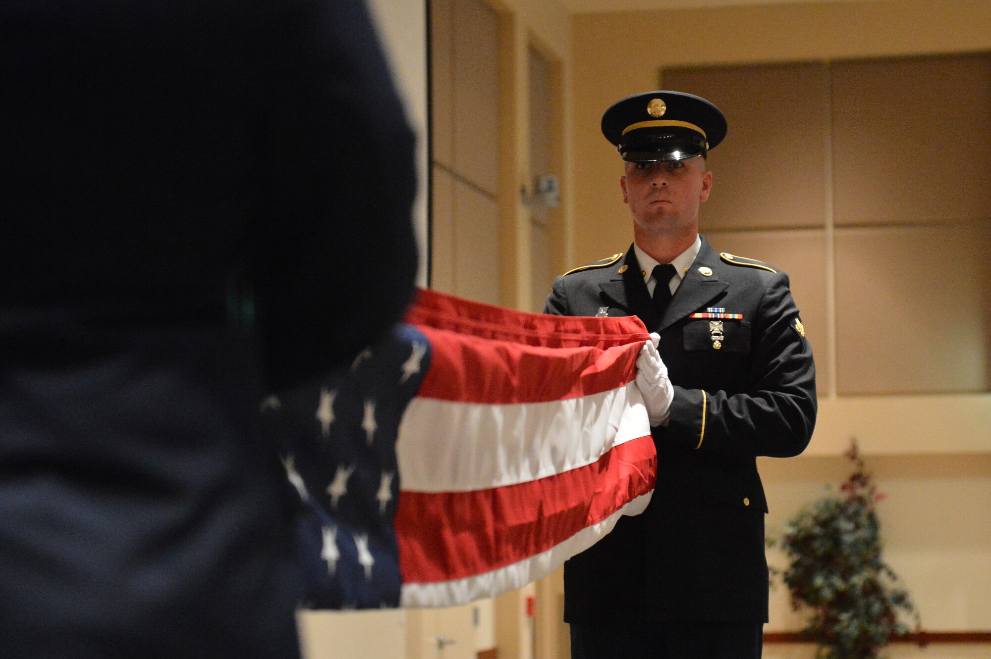 Members of the Aerospace Data Facility-Colorado Joint Color Guard fold a U.S. flag during the Veterans Day ceremony at the Leadership Development Center Nov. 13, 2015, on Buckley Air Force Base, Colo. Aside from the flag-folding ceremony, the event included a guest speaker. (U.S. Air Force photo by Staff Sgt. Darren Scott/Released)