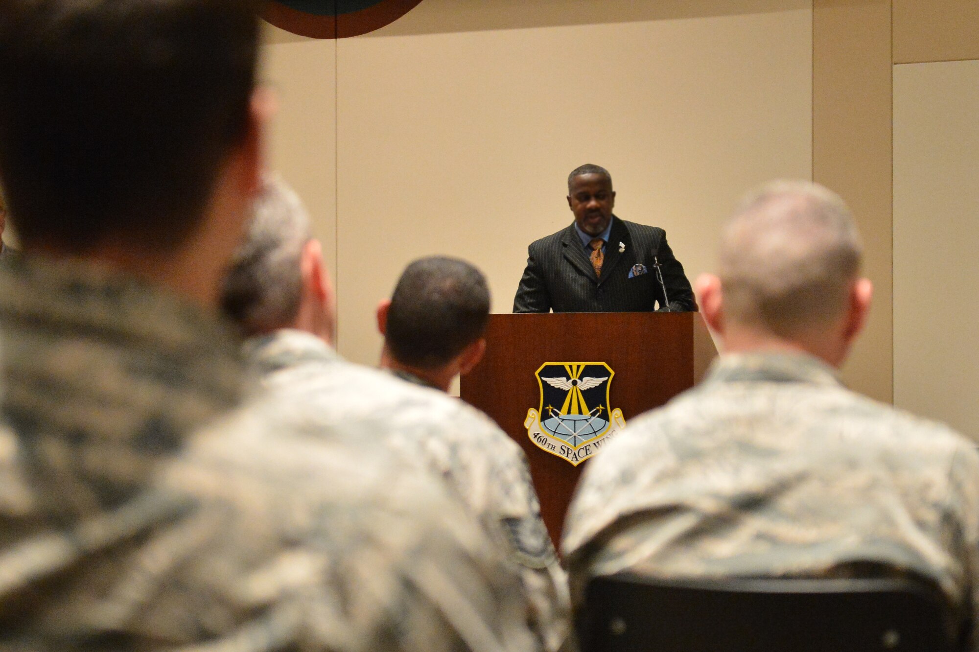 Retired Master Chief Petty Officer Danny Moore speaks to Team Buckley members during the Veterans Day ceremony at the Leadership Development Center Nov. 13, 2015, on Buckley Air Force Base, Colo. In addition, the ceremony included a flag-folding ceremony performed by the Aerospace Data Facility-Colorado Joint Color Guard. (U.S. Air Force photo by Staff Sgt. Darren Scott/Released)