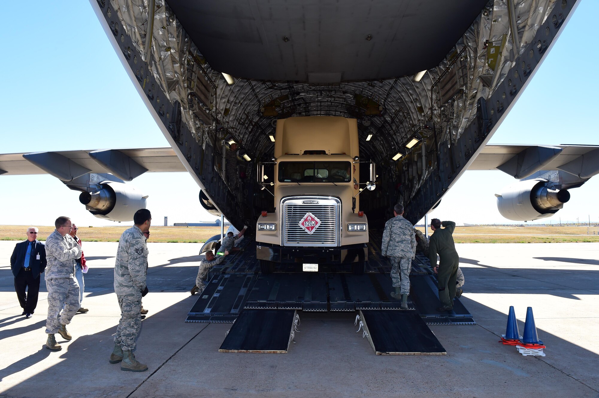 Team Buckley members watch as the 233rd Space Group’s mobile ground station loads onto a C-17 Globemaster III during Panther Thunder Nov. 2, 2015, on Buckley Air Force Base, Colo.  The exercise scenario tested the 233rd SG’s ability to rapidly deploy their assets in case of satellite failure. Panther Thunder is Buckley AFB's version of the Strategic Command exercise, Global Thunder, which is an Air Force-wide exercise that focuses on all combatant commands and their missions.  (U.S. Air Force photo by Airman 1st Class Samantha Meadors/Released)