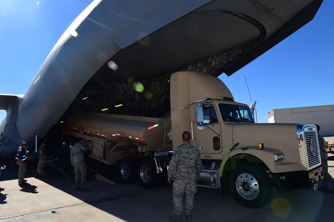 A Team Buckley member observes the 233rd Space Group’s mobile ground station load onto a C-17 Globemaster III during Panther Thunder Nov. 2, 2015, on Buckley Air Force Base, Colo.  The exercise scenario tested the 233rd SG’s ability to rapidly deploy their assets in case of satellite failure. Panther Thunder is Buckley AFB's version of the Strategic Command exercise, Global Thunder, which is an Air Force-wide exercise that focuses on all combatant commands and their missions.  (U.S. Air Force photo by Airman 1st Class Samantha Meadors/Released)