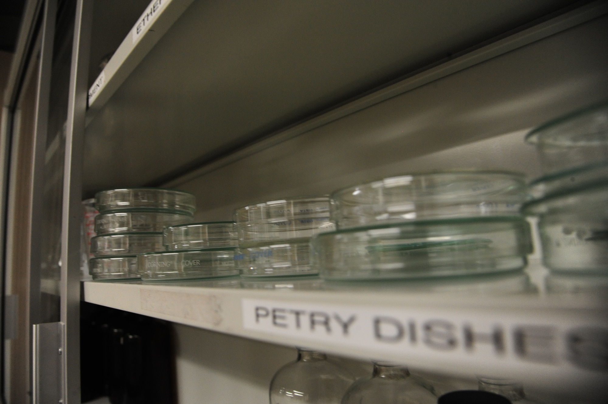 Rows of petry dishes lie across a shelf at Whiteman Air Force Base, Mo., Nov. 3, 2015. Fuel samples are placed into petry dishes as part of the process to check for impurities. (U.S. Air Force photo by Senior Airman Keenan Berry)