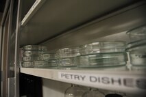 Rows of petry dishes lie across a shelf at Whiteman Air Force Base, Mo., Nov. 3, 2015. Fuel samples are placed into petry dishes as part of the process to check for impurities. (U.S. Air Force photo by Senior Airman Keenan Berry)