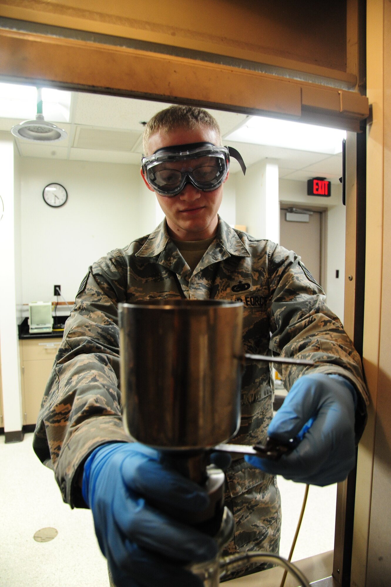 U.S. Air Force Staff Sgt. Nicholas Flamm, a 509th Logistics Readiness Squadron fuels service center operator, performs fuel testing at Whiteman Air Force Base, Mo., Nov. 3, 2015. The testing process ensures the fuel is filtered properly and potential contaminants do not settle to the bottom of the container. (U.S. Air Force photo by Senior Airman Keenan Berry)