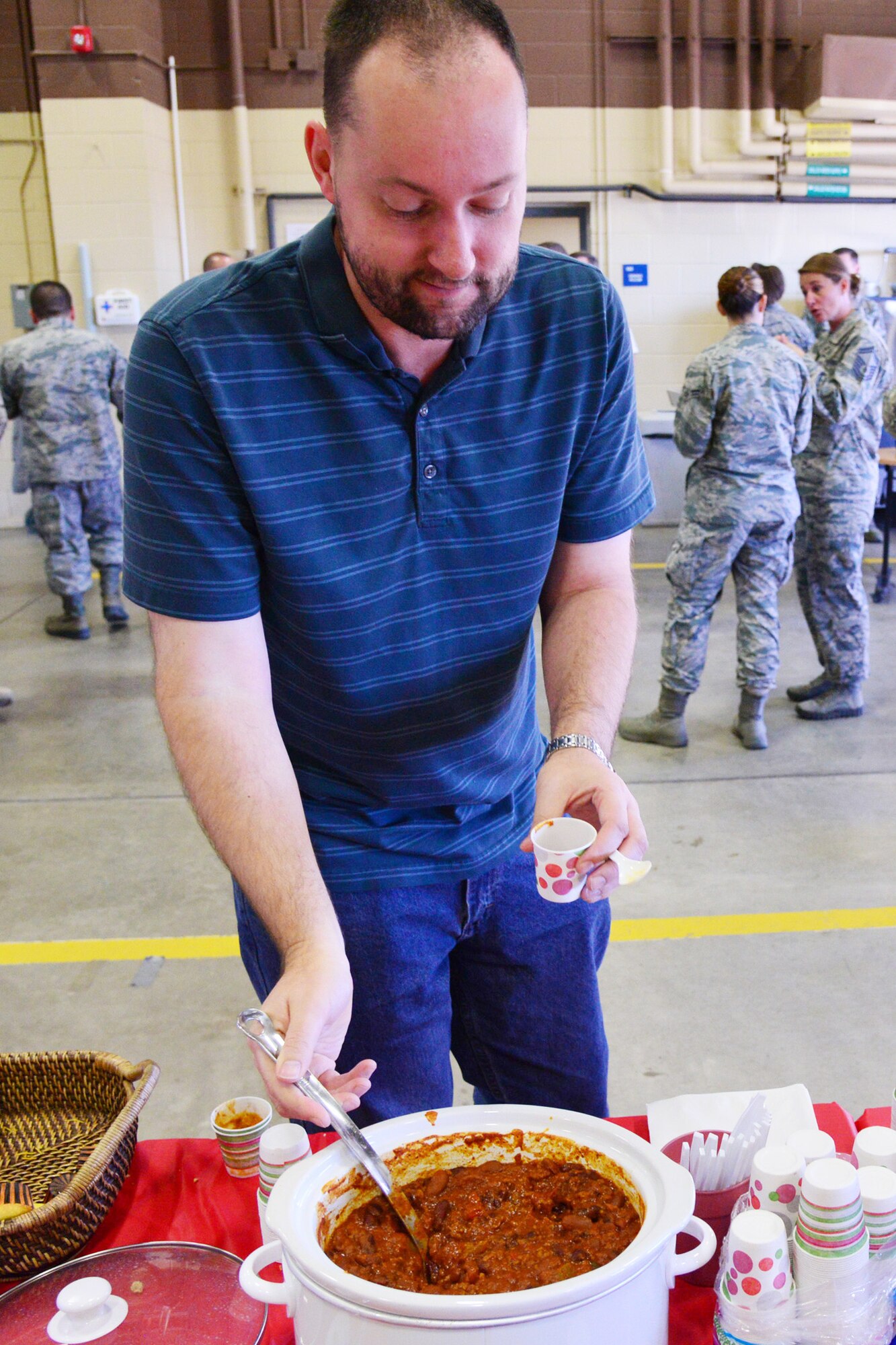 A Team Malmstrom member attends the inaugural 341st Mission Support Group Chili Cook Off Nov. 6, 2015, at Malmstrom Air Force Base, Mont. Approximately 75 Airmen from all across the base came out to enjoy tasting from several different chilies. (U.S. Air Force photo/Airman Daniel Brosam)