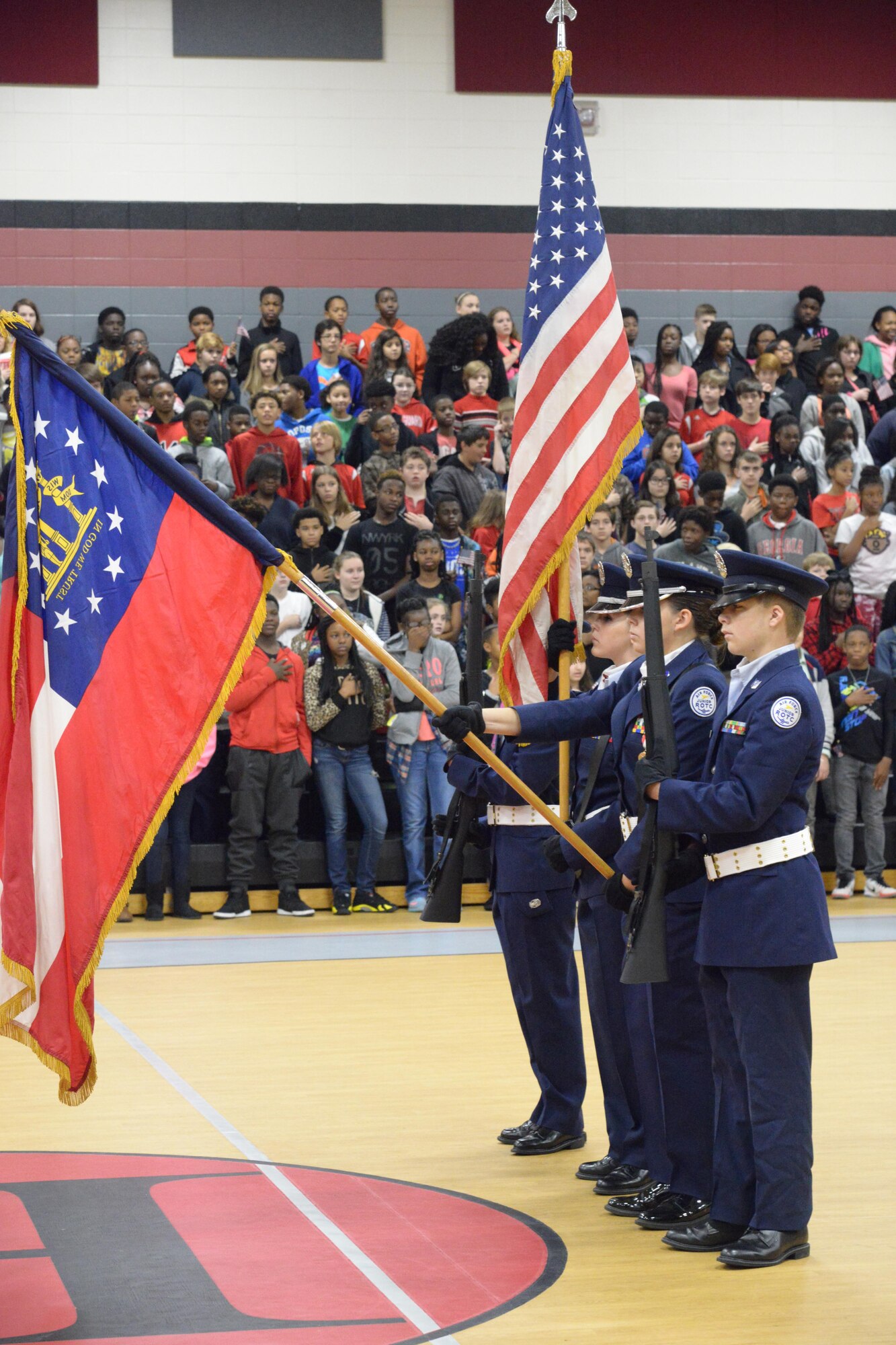Members of the Warner Robins High School JROTC Honor Guard present the colors during a salute to veterans at Huntington Middle School, Nov. 10, 2015 (U.S. Air Force photo by Ray Crayton)