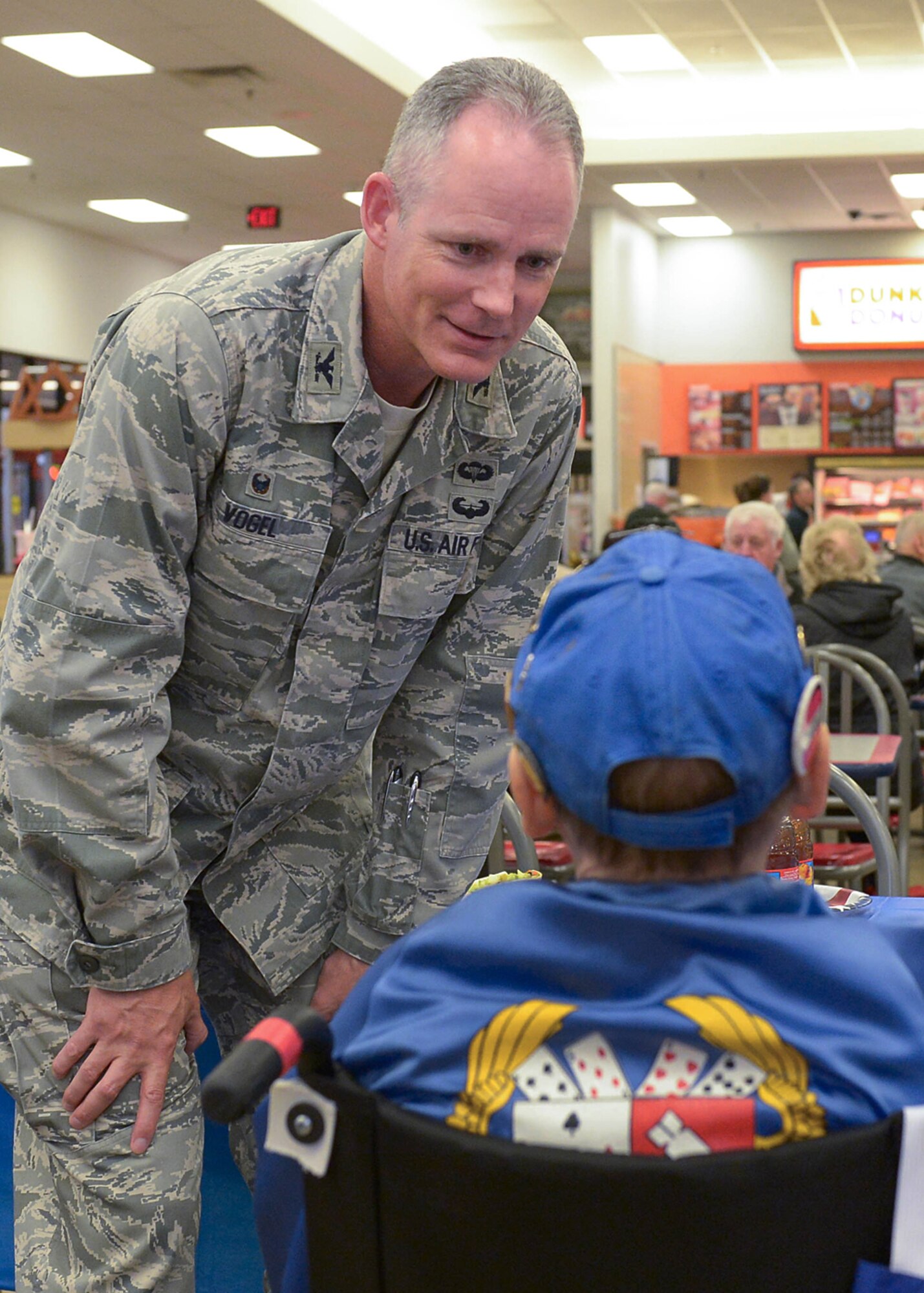 Col. Michael A. Vogel, 66th Air Base Group commander, speaks to a disabled veteran at the Army and Air Force Exchange Service lobby Nov. 12. Several local towns surrounding Hanscom honored military service members as part of Veterans Day observances. (U.S. Air Force photo by Jerry Saslav)