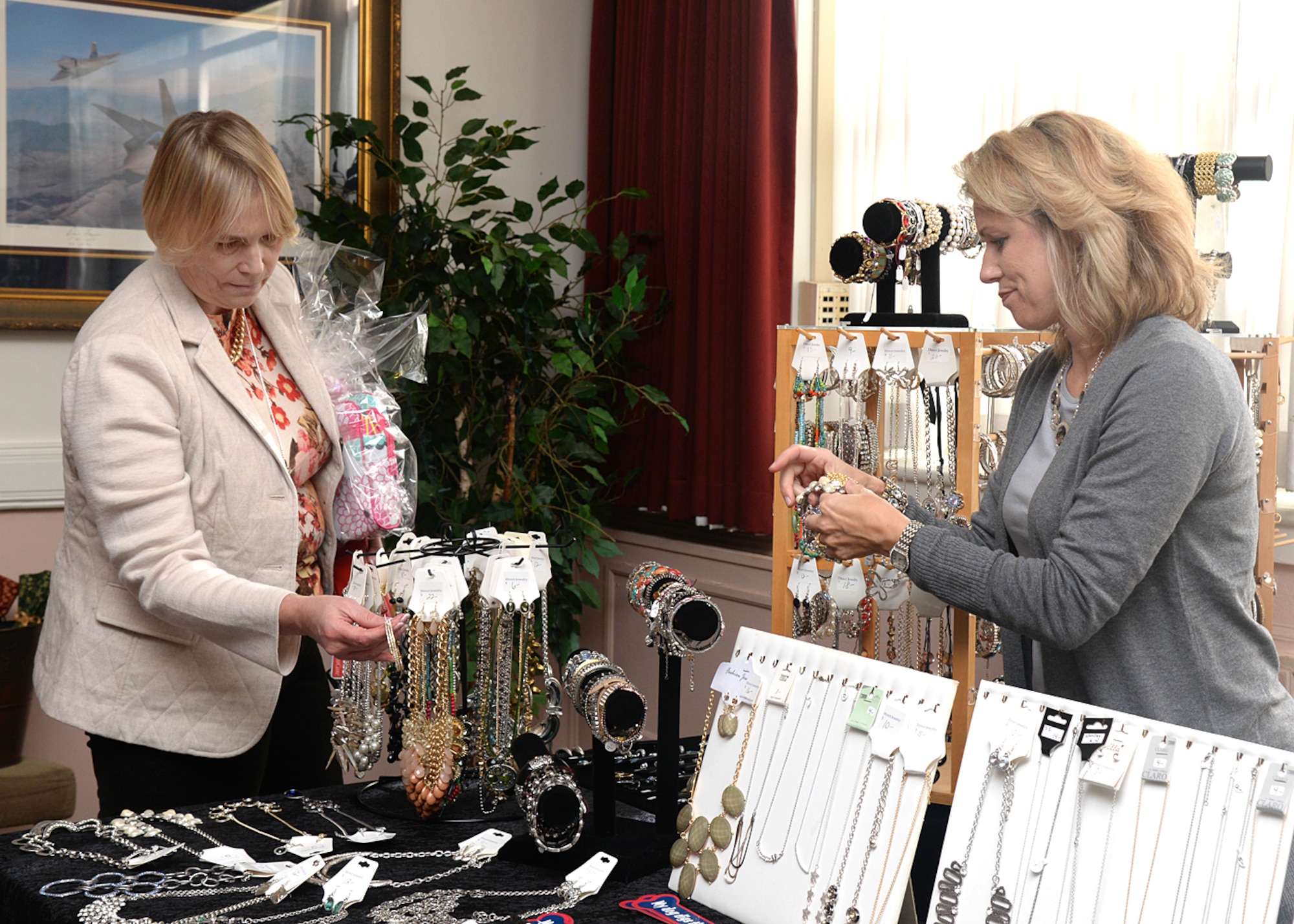 Kari Perez, left, looks at jewelry being offered by Cindy Canavan, right, during the Hanscom Spouse Club Holiday Bazaar at the Minuteman Commons Nov. 13. The Hanscom community was invited to the bazaar to shop from a selection of jewelry, ornaments, handmade gifts, gift bags and more from a wide variety of vendors. (U.S. Air Force photo by Linda LaBonte Britt)