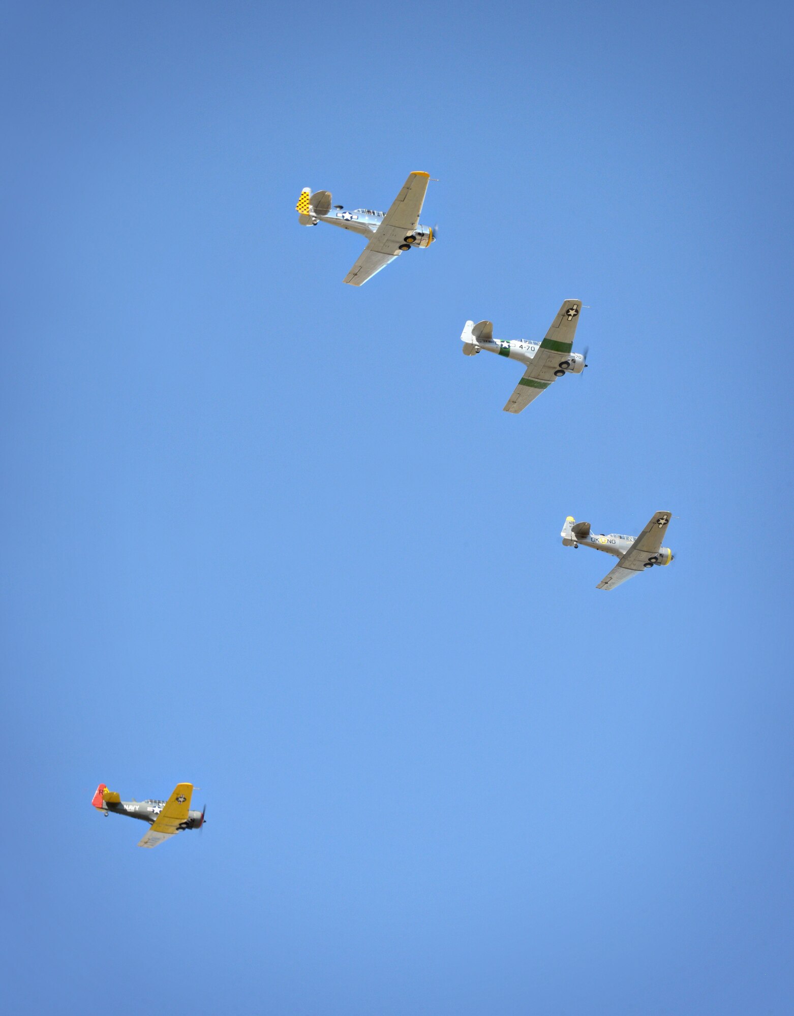 The War Birds, a World War II aircraft group from Tulsa, perform a fly-over in T-6 Texan aircraft.  (Air Force photo by Kelly White/Released)