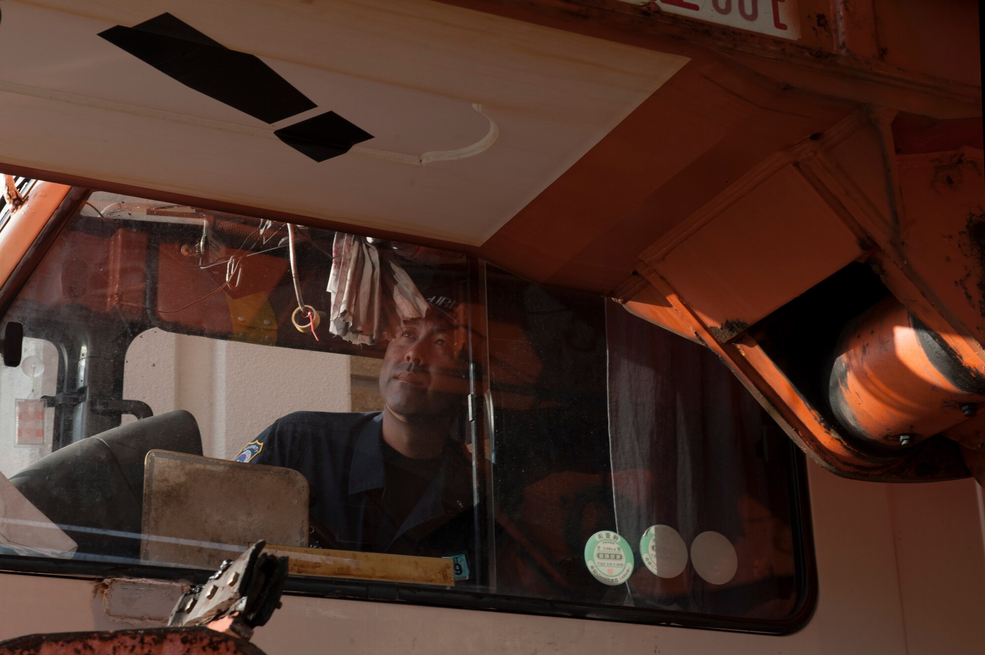 Tomohiro Nakada, 18th Security Forces Squadron member, searches a vehicle Nov. 10, 2015, inside the search pit at Kadena Air Base, Japan.  Leadership from different squadrons on Kadena came up with a solution to help alleviate traffic congestion on roads surrounding Kadena AB. (U.S. Air Force photo by Airman 1st Class Lynette M. Rolen)