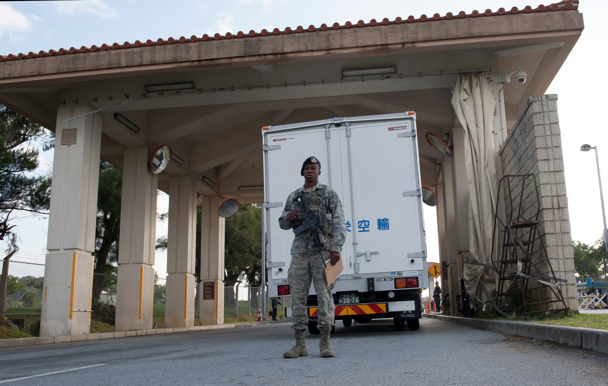 U.S. Air Force Airman 1st Class Alvin Stewart, 18th Security Forces Squadron response force member, waits for trucks to arrive to a search pit Nov. 10, 2015, at Kadena Air Base, Japan. An Air Force Smart Operations for the 21st Century team on Kadena implemented an earlier search time for commercial vehicles to keep them from congesting traffic while waiting to get on base. (U.S. Air Force photo by Airman 1st Class Lynette M. Rolen)