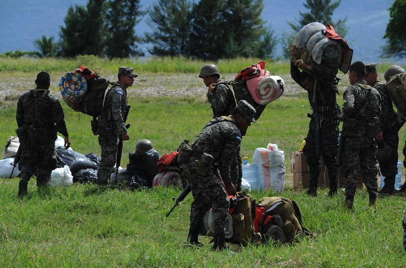 Honduran soldiers grab their gear as they prepare to board a U.S. Army UH-60 Blackhawk, Nov. 4, 2015, in the Gracias a Dios department (state) of Honduras. The soldiers were a part of a troop movement to rotate with forward operating locations in the area. (U.S. Air Force photo by Capt. Christopher J. Mesnard/Released)