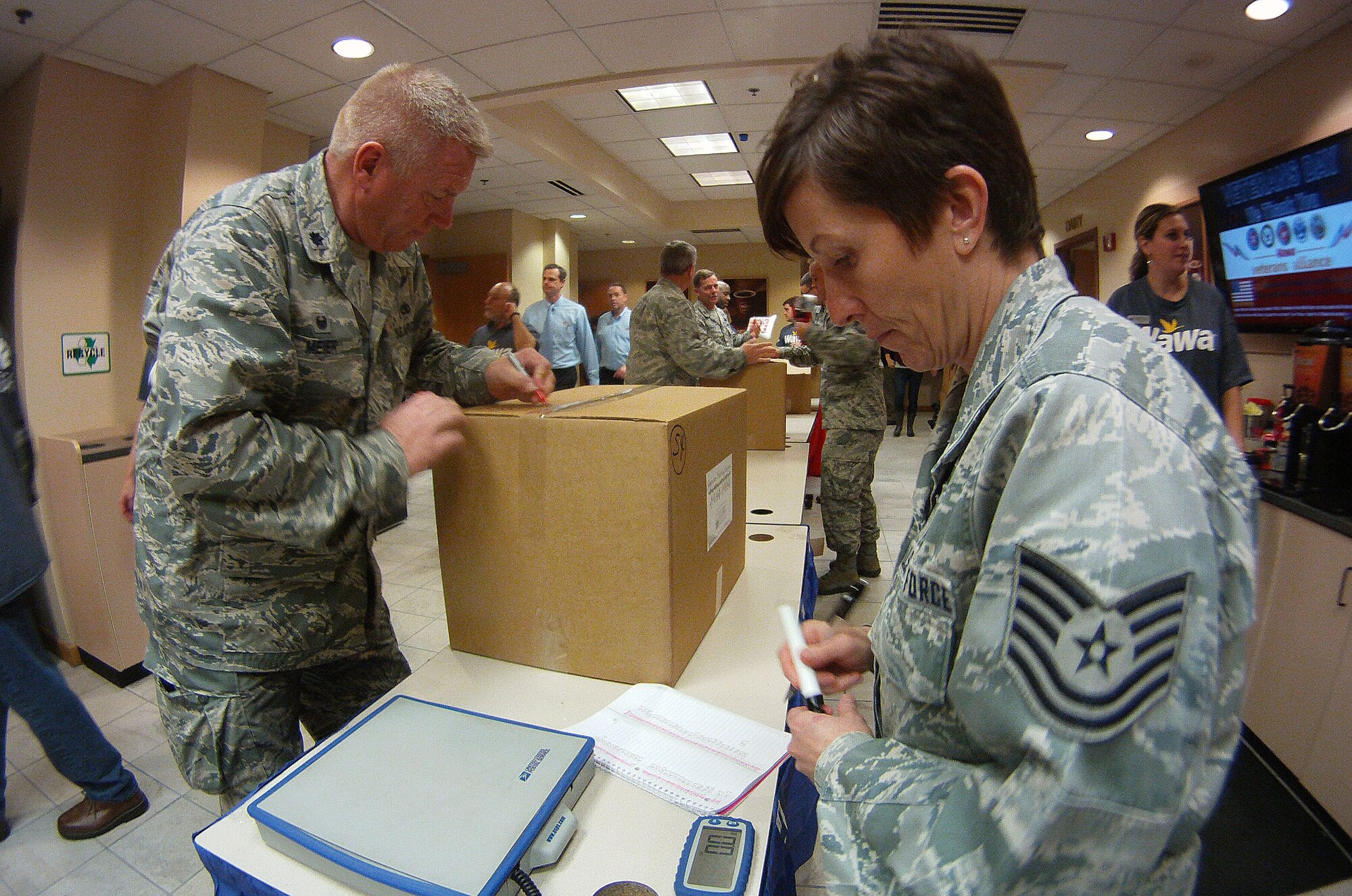 Lt. Col Scott Meier, left, Deputy Group Commander for the 111th Air Operations Group here and Tech. Sgt. Danielle Heidrick, 111th AOG assistance commander support staff, weigh, inventory and stack nearly 8,000 pounds of Wawa, Inc., care packages destined for deployed servicemen and women in Media, Pennsylvania on Nov. 10, 2015. This marks the fifth year teams from the Pennsylvania Air and Army National Guard have participated in the Wawa “Taste of Home” build benefiting the Liberty USO. (U.S. Air National Guard photo by Master Sgt. Christopher Botzum/Released)  