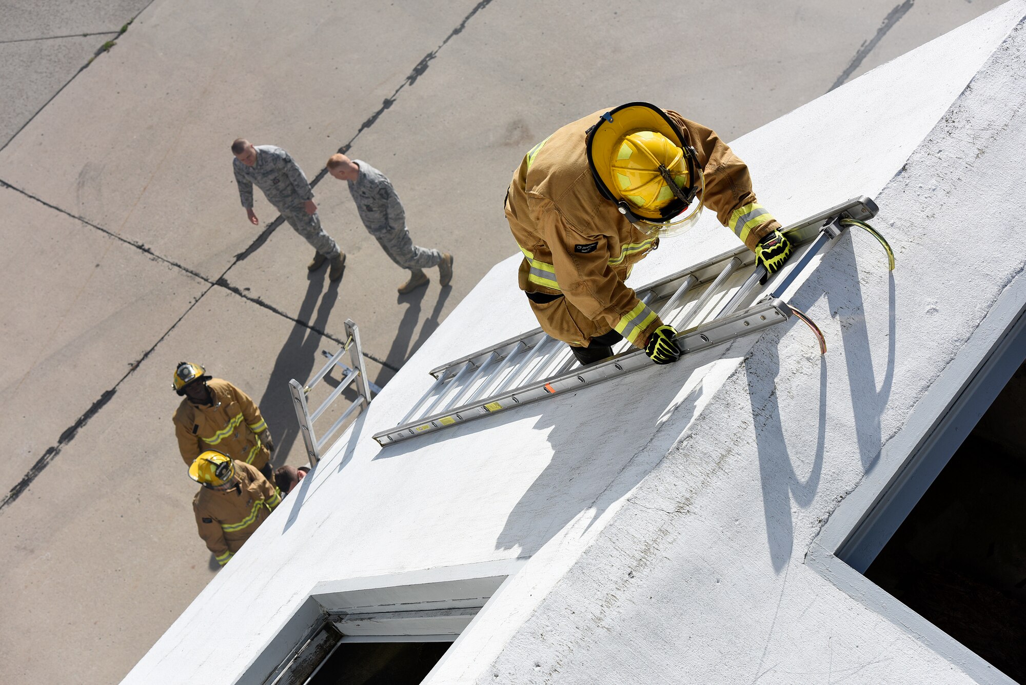 A U.S. Air National Guard firefighter assigned to the 180th Fighter Wing ascends a ladder during a Regularly Scheduled Drill training exercise Nov. 7, 2015 in Swanton, Ohio at a specialized training facility owned by the Toledo Fire Department. The 180th Fighter Wing partners with the Toledo Fire Department and other civil authorities to share resources and maximize training benefits. (U.S. Air National Guard photo by Staff Sgt. Shane Hughes/Released)