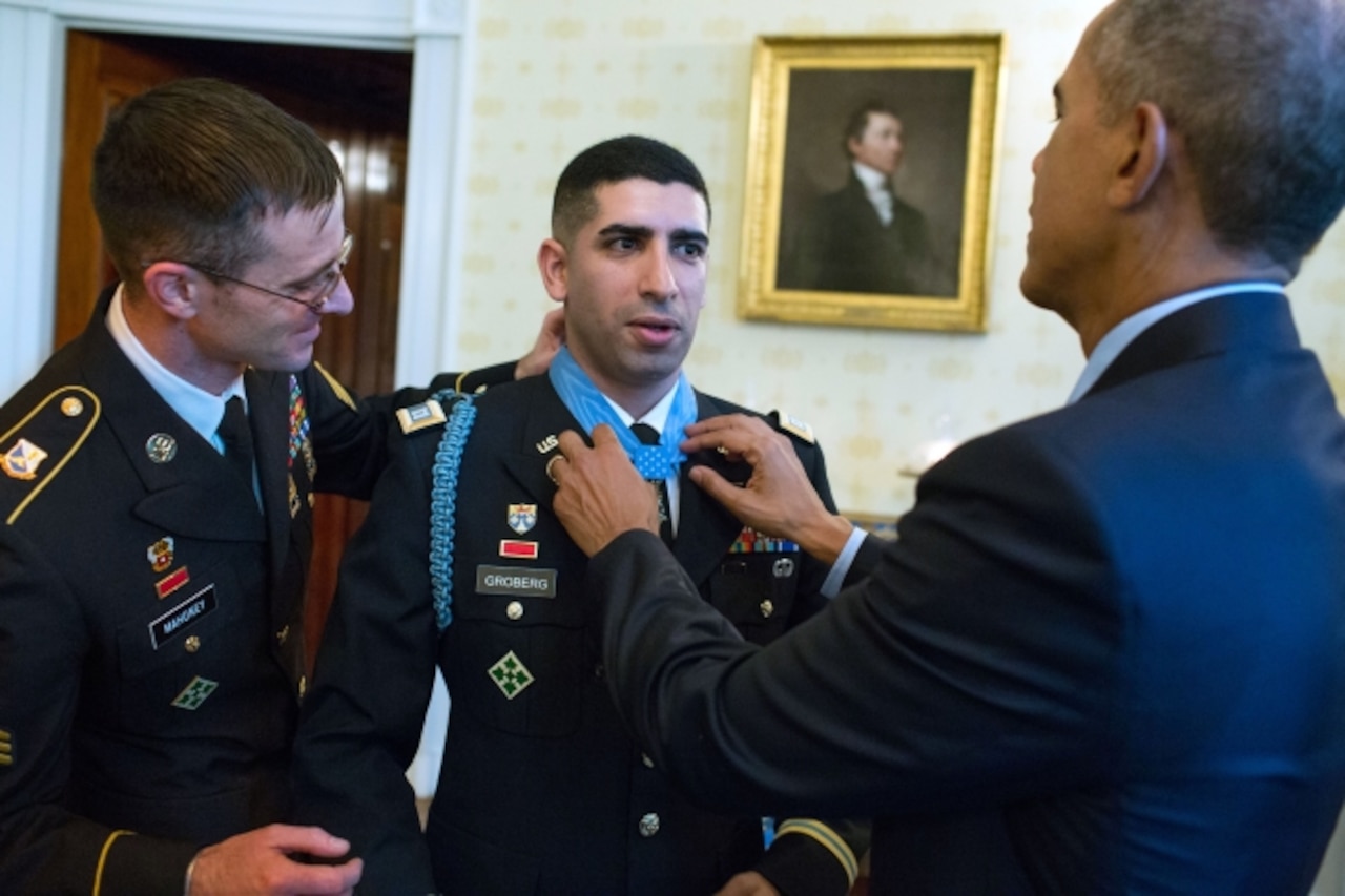 President Barack Obama, along with with Army Sgt. Andrew Mahoney, adjusts the Medal of Honor on retired Army Capt. Florent A. Groberg in the Blue Room of the White House, Nov. 12, 2015. Groberg received the Medal of Honor for his courageous actions while serving as a personal security detachment commander for Task Force Mountain Warrior, 4th Infantry Brigade Combat Team, 4th Infantry Division, during combat operations in Afghanistan’s Kunar province, Aug. 8, 2012. White House photo by Pete Souza