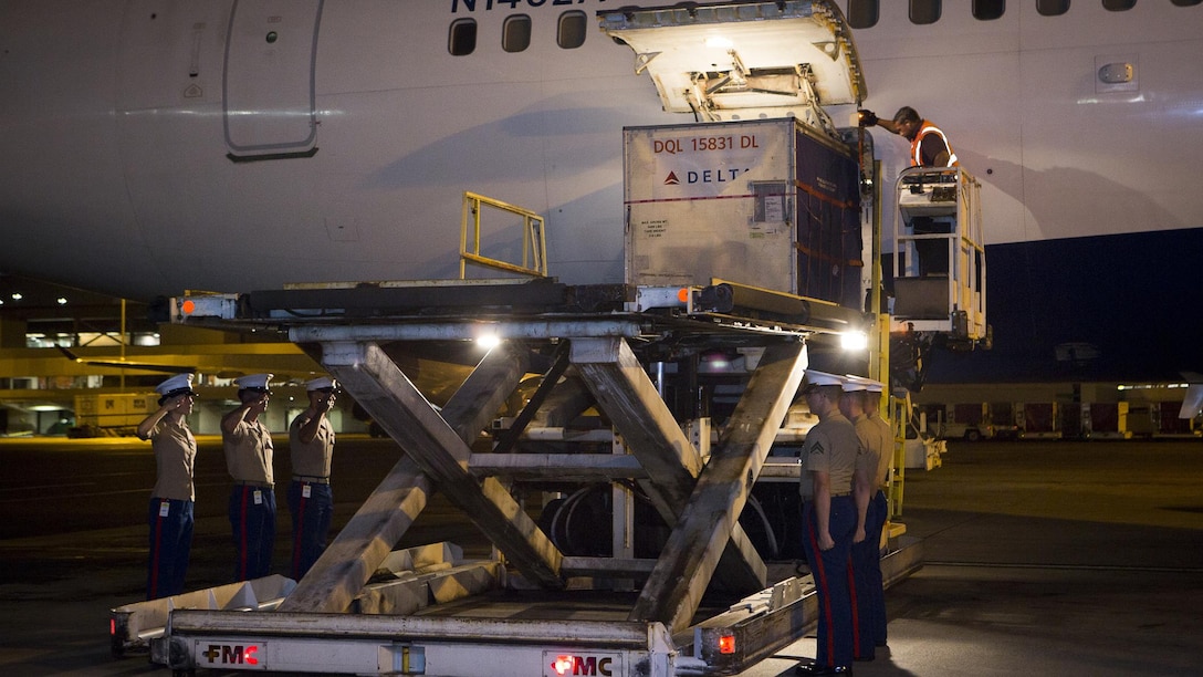 Marines with U.S. Marine Corps Forces, Pacific salute Cpl. Roger K. Nielson during a dignified transfer of remains at the Honolulu International Airport, Nov. 12, 2015. Nielson was a World War II Marine assigned to Company E, 2nd Battalion, 8th Marine Regiment, 2nd Marine Division, who was killed during the battle of Tarawa, where more than 18,000 Marines fought and more than 1,000 were killed over three days of fighting. 