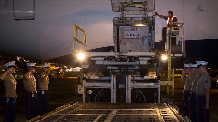 Marines with U.S. Marine Corps Forces, Pacific salute Cpl. Roger K. Nielson during a dignified transfer of remains at the Honolulu International Airport, Nov. 12, 2015. Nielson was a World War II Marine assigned to Company E, 2nd Battalion, 8th Marine Regiment, 2nd Marine Division, who was killed during the battle of Tarawa, where more than 18,000 Marines fought and more than 1,000 were killed over three days of fighting. 