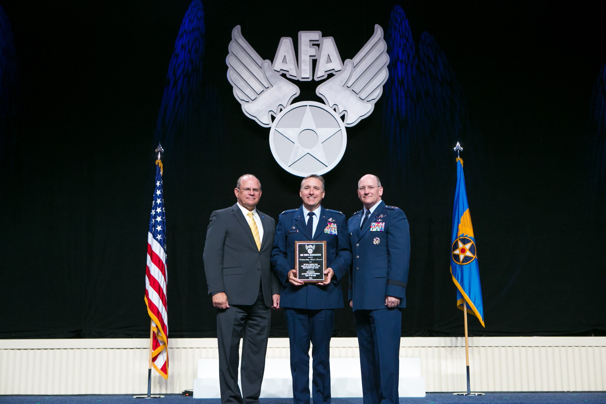 WASHINGTON - Col. John Breazeale, center, 301st Fighter Wing commander, poses for a photo and he receives the 2015 Air Force Association's Air Force Reserve Wing award plaque here Sept. 14, 2015, from Scott Van Cleef, left, Air Force Association Chairman of the Board, and Lt. Gen. James Jackson, right, Air Force Reserve Command commander. (Courtesy photo)