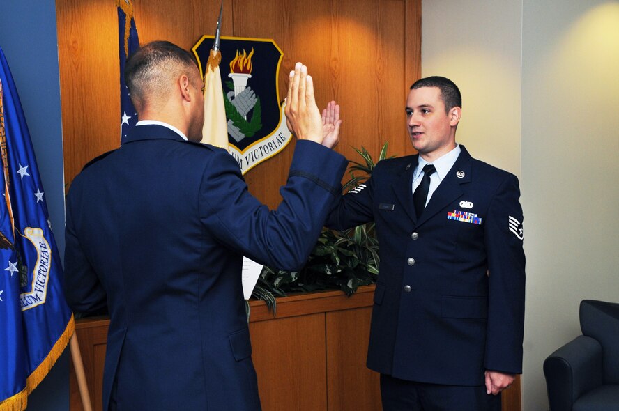 Staff Sgt. Brian Carney, paralegal specialist with the 108th Wing Judge Advocate office is administered the officer's oath of office by Maj. Hector Ruiz, 108th Wing Staff Judge Advocate and is subsequently promoted to the rank of 1st Lt. at Joint Base McGuire-Dix-Lakehurst, N.J., Sept. 19, 2015. (U.S. Air National Guard photo by Master Sgt. Carl Clegg/Released)