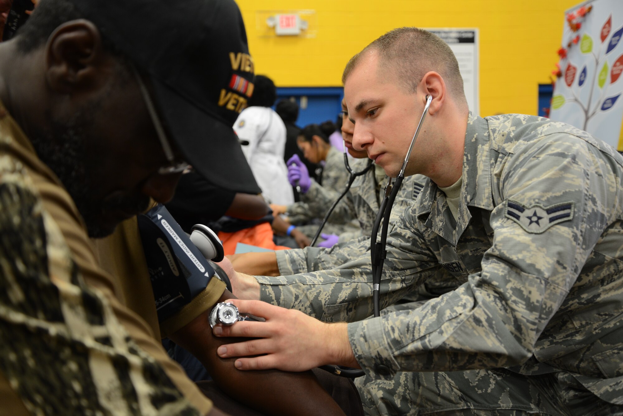 Airman 1st Class Daniel Hansen, 108th Medical Group, New Jersey Air National Guard, checks the blood pressure of a homeless veteran at the New Jersey Department of Military and Veterans Affairs Stand Down Day at the John F. Kennedy recreation center in Newark, N.J. On Oct. 10, 2015. The stand down day allows the veterans to get much needed care and services from a wide array of state agencies and nonprofit organizations. Members of the 108th Medical Group have been providing care at stand down days for more than 10 years and were providing blood pressure checks as a means to have conversations with the veterans about their overall health and wellness. Stand Down is a military term referring to exhausted combat units that were removed from the battlefront to a place of security and safety for rest and recovery. Today, Stand Downs are grass roots, community-based intervention program to help veterans' battle life on the streets. (U.S. Air National Guard photo by Master Sgt. Carl Clegg, Released)

