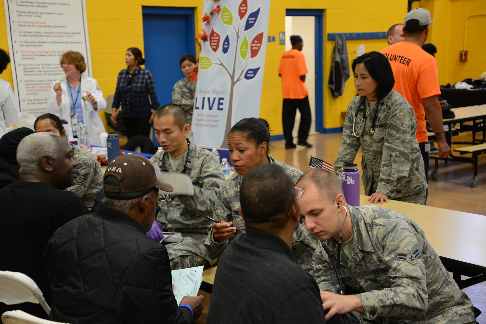 Members of the 108th Medical Group, New Jersey Air National Guard, provide blood pressure checks to homeless veterans at the New Jersey Department of Military and Veterans Affairs Stand Down Day at the John F. Kennedy recreation center in Newark, N.J. On Oct. 10, 2015. The stand down day allows the veterans to get much needed care and services from a wide array of state agencies and nonprofit organizations. Members of the 108th Medical Group have been providing care at stand down days for more than 10 years and were providing blood pressure checks as a means to have conversations with the veterans about their overall health and wellness. Stand Down is a military term referring to exhausted combat units that were removed from the battlefront to a place of security and safety for rest and recovery. Today, Stand Downs are grass roots, community-based intervention program to help veterans' battle life on the streets. (U.S. Air National Guard photo by Master Sgt. Carl Clegg, Released)

