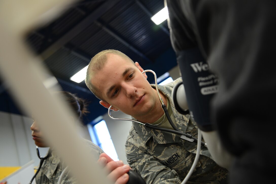 Airman 1st Class Daniel Hansen, 108th Medical Group, New Jersey Air National Guard, checks the blood pressure of a homeless veteran at the New Jersey Department of Military and Veterans Affairs Stand Down Day at the John F. Kennedy recreation center in Newark, N.J. On Oct. 10, 2015. The stand down day allows the veterans to get much needed care and services from a wide array of state agencies and nonprofit organizations. Members of the 108th Medical Group have been providing care at stand down days for more than 10 years and were providing blood pressure checks as a means to have conversations with the veterans about their overall health and wellness. Stand Down is a military term referring to exhausted combat units that were removed from the battlefront to a place of security and safety for rest and recovery. Today, Stand Downs are grass roots, community-based intervention program to help veterans' battle life on the streets. (U.S. Air National Guard photo by Master Sgt. Carl Clegg, Released)

