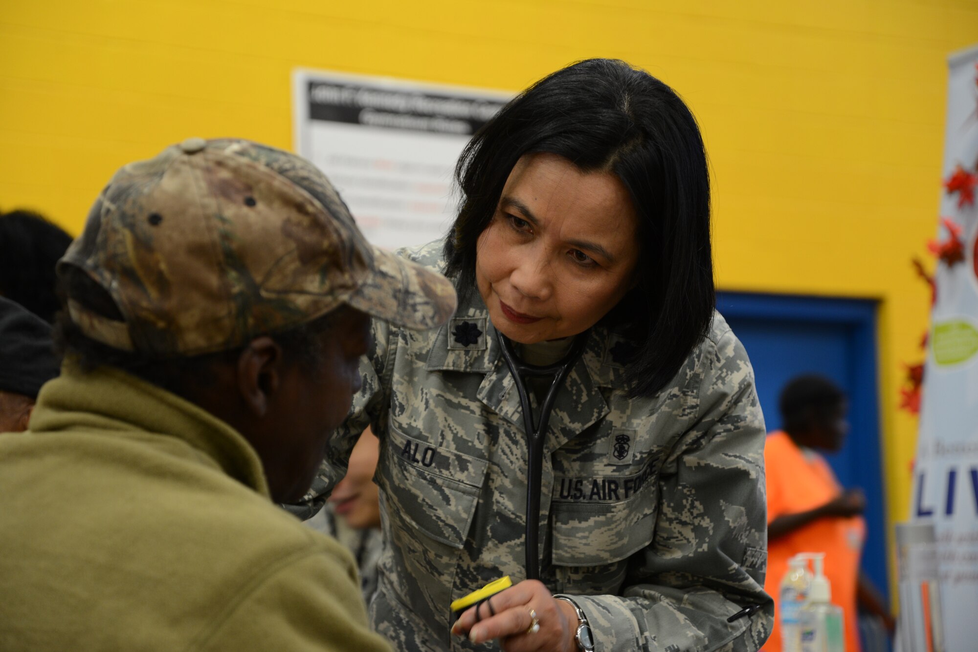Lt. Col. Mauricia Alo, 108th Medical Group, New Jersey Air National Guard, checks the blood pressure of a homeless veteran at the New Jersey Department of Military and Veterans Affairs Stand Down Day at the John F. Kennedy recreation center in Newark, N.J. On Oct. 10, 2015. The stand down day allows the veterans to get much needed care and services from a wide array of state agencies and nonprofit organizations. Members of the 108th Medical Group have been providing care at stand down days for more than 10 years and were providing blood pressure checks as a means to have conversations with the veterans about their overall health and wellness. Stand Down is a military term referring to exhausted combat units that were removed from the battlefront to a place of security and safety for rest and recovery. Today, Stand Downs are grass roots, community-based intervention program to help veterans' battle life on the streets. (U.S. Air National Guard photo by Master Sgt. Carl Clegg, Released)