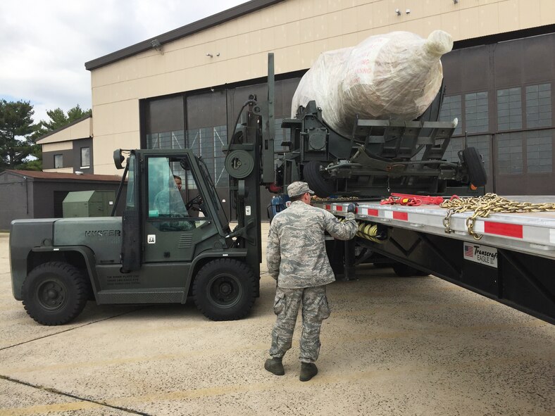 Members of the 108th Wing’s Vehicle Maintenance office use a forklift to retrieve an aircraft engine from a truck at Joint Base McGuire-Dix-Lakehurst, N.J., Oct. 8, 2015. The General Electric F-108 model engine, valued at more than $3 million, was expedited from the 134th Air Refueling Wing of the Tennessee Air National Guard and brought to JB MDL by truck in an effort to keep the Stratotankers of the 108th Wing flying. (U.S. Air National Guard Photo by Master Sgt. Carl Clegg/Released)
