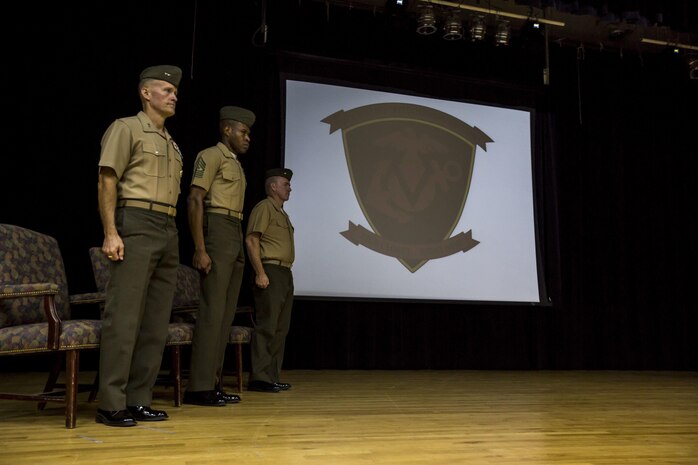 From left, U.S. Marine Corps Maj. Gen. Carl E. Mundy III, commanding general, Sgt. Maj. Clifford W. Wiggins, sergeant major, and U.S. Navy Cmdr. Steven D. Mills, chaplain, all with the 5TH Marine Expeditionary Brigade (MEB) stand during the playing of the Marines' Hymn at the 5TH MEB activation ceremony aboard Naval Support Activity Bahrain, Oct. 15, 2015. The unit, formerly known as Command Element Marine Corps Forces Command, Central Command Forward, was re-designated as the 5TH MEB to more accurately reflect Marine Corps organizational doctrine, and will continue to provide a forward-deployed headquarters in the U.S. Central Command area of responsibility. (U.S. Marine Corps photo by Cpl. Sean Searfus 5th MEB COMCAM / Released)