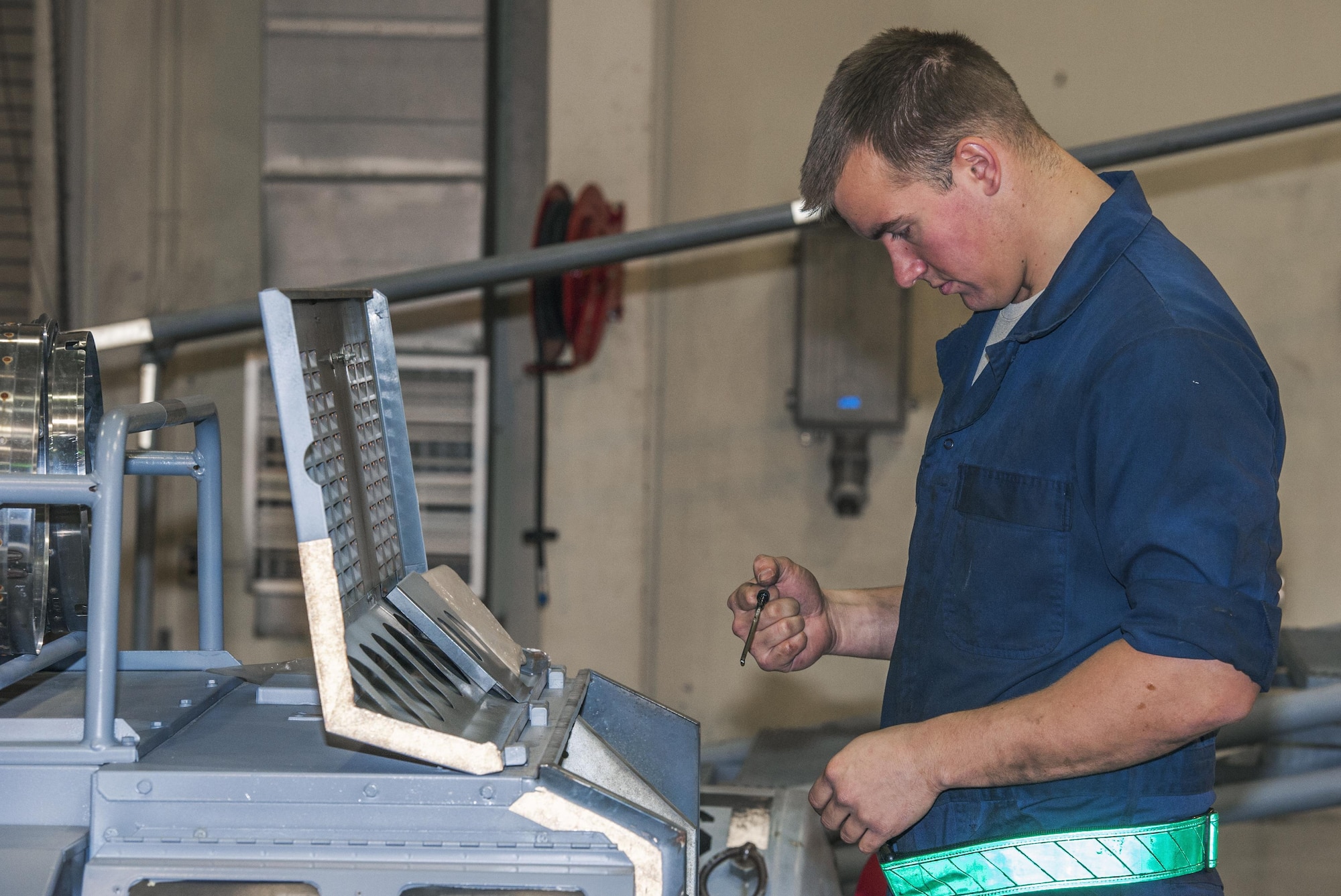Senior Airman Nicholas Appenzeller, 8th Maintenance Squadron aerospace ground equipment journeyman, looks into the control panel of a heater to check the status of the liquids inside at Kunsan Air Base, Republic of Korea, Nov. 10, 2015. The heater is used during the winter time to provide heat for crew chiefs who work outside in extreme cold temperatures. (U.S. Air Force photo by Staff Sgt. Nick Wilson/Released)