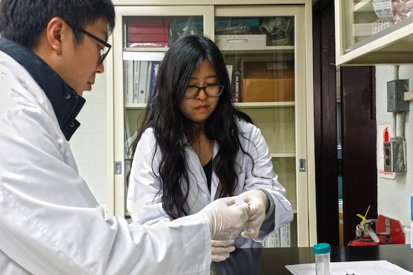 Mr. Yo-Sep Song demonstrates a field testing kit to student Kelly Wun. The field testing kit is used for screening of petroleum contaminated soil. Ms. Wun is a senior at Seoul American High School, and shadowed Far East District staff members on Nov. 5, 2015 to learn more about what they do. Mr. Song is a chemist in the Geotechnical and Environmental Engineering Branch in the Far East District of the U.S. Army Corps of Engineers. (Photo courtesy of Dr. Son-Chu Chon, U.S. Army Corps of Engineers)