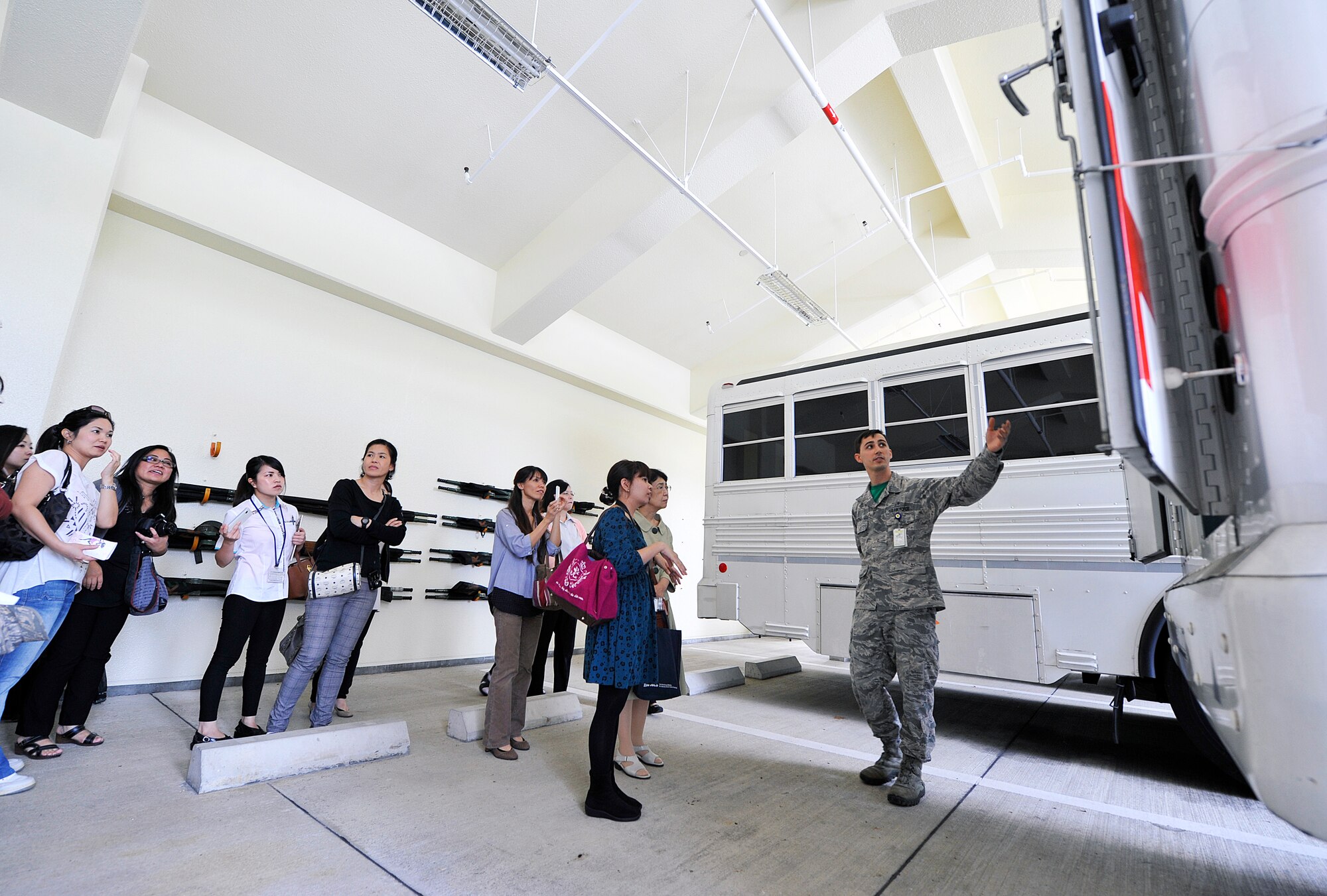 U.S. Air Force Senior Airman Coleman Warner, 18th Medical Operations Squadron aeromedical staging technician, shows the inside of the medical ambulance bus to local medical interpreter students, Nov. 13, 2015, at Kadena Air Base, Japan. During the visit, students learned more about the military medical systems as well as building closer friendships. (U.S. Air Force photo by Naoto Anazawa)

