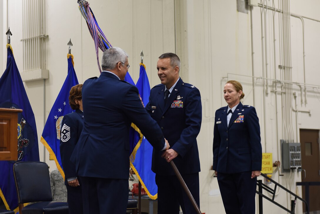 Col. Benjamin (Mike) Cason (center) receives the 193rd Special Operations Wing guidon from Brig. Gen. Tony Carrelli, commander, Pennsylvania Air National Guard, during a change-of-command ceremony on base Nov. 14. Cason, a command pilot with more than 4,500 flying hours, is the first dual-status commander of an Air Force Special Operations Command Unit. He is now responsible for leading one of the most deployed wings in the Air National Guard. (U.S. Air National Guard photo by Senior Airman Ethan Carl/Released)