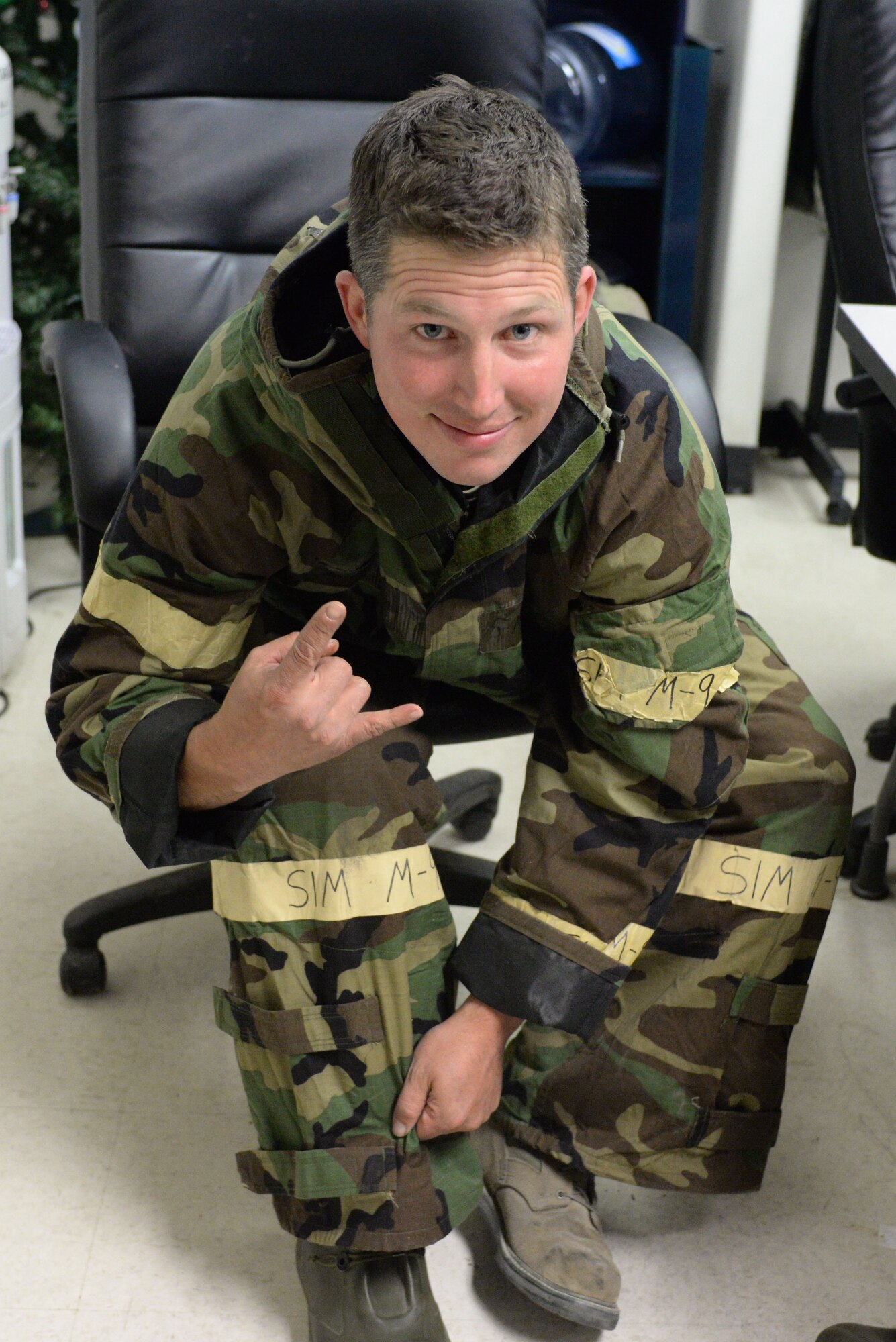 U.S. Air Force Tech. Sgt. Andrew M. Campbell, assigned to 140th Fuels Maintenance Shop, Colorado Air National Guard, puts his chemical gear on, simulating a chemical attack, for the wing wartime readiness inspection at Buckley Air Force Base, Colo., Oct. 16, 2015. Campbell is a full time fuel shop technician at Buckley during the week. (U.S. Air National Guard photo by Senior Airman Bobbie Reynolds)
