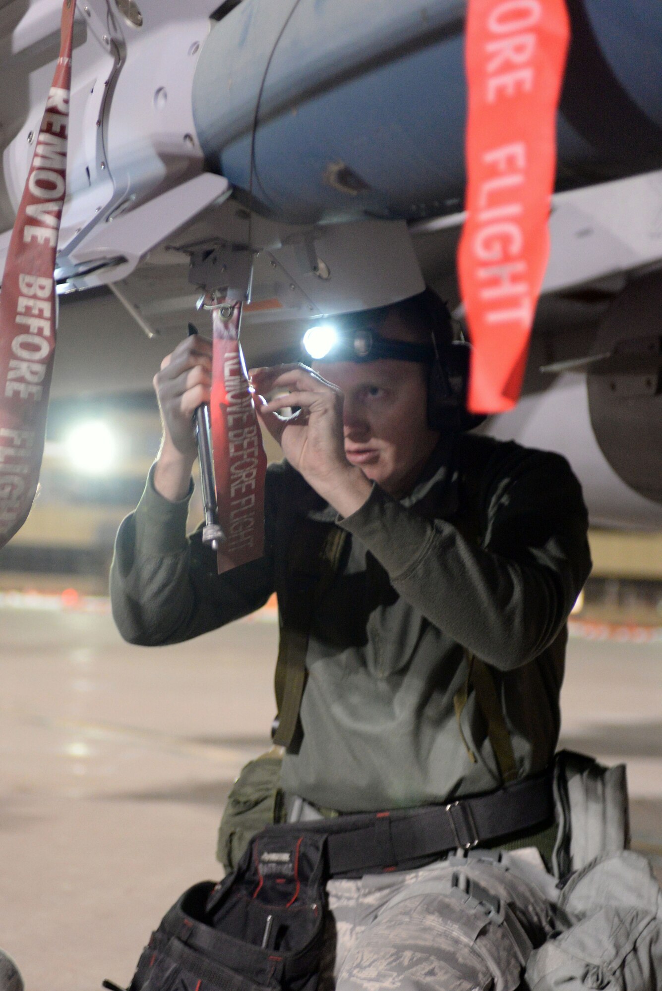 U.S. Air Force Staff Sgt. Spencer K. Brauer, assigned to 140th Weapons Maintenance, Colorado Air National Guard, loads a bomb in preparation for a night flying exercise at Buckley Air Force Base in Aurora, Colo., during the wing wartime readiness inspection Oct. 16, 2015. Brauer has worked with the maintenance team on the flight line loading and unloading bombs on aircraft. (U.S. Air National Guard photo by Senior Airman Bobbie Reynolds)