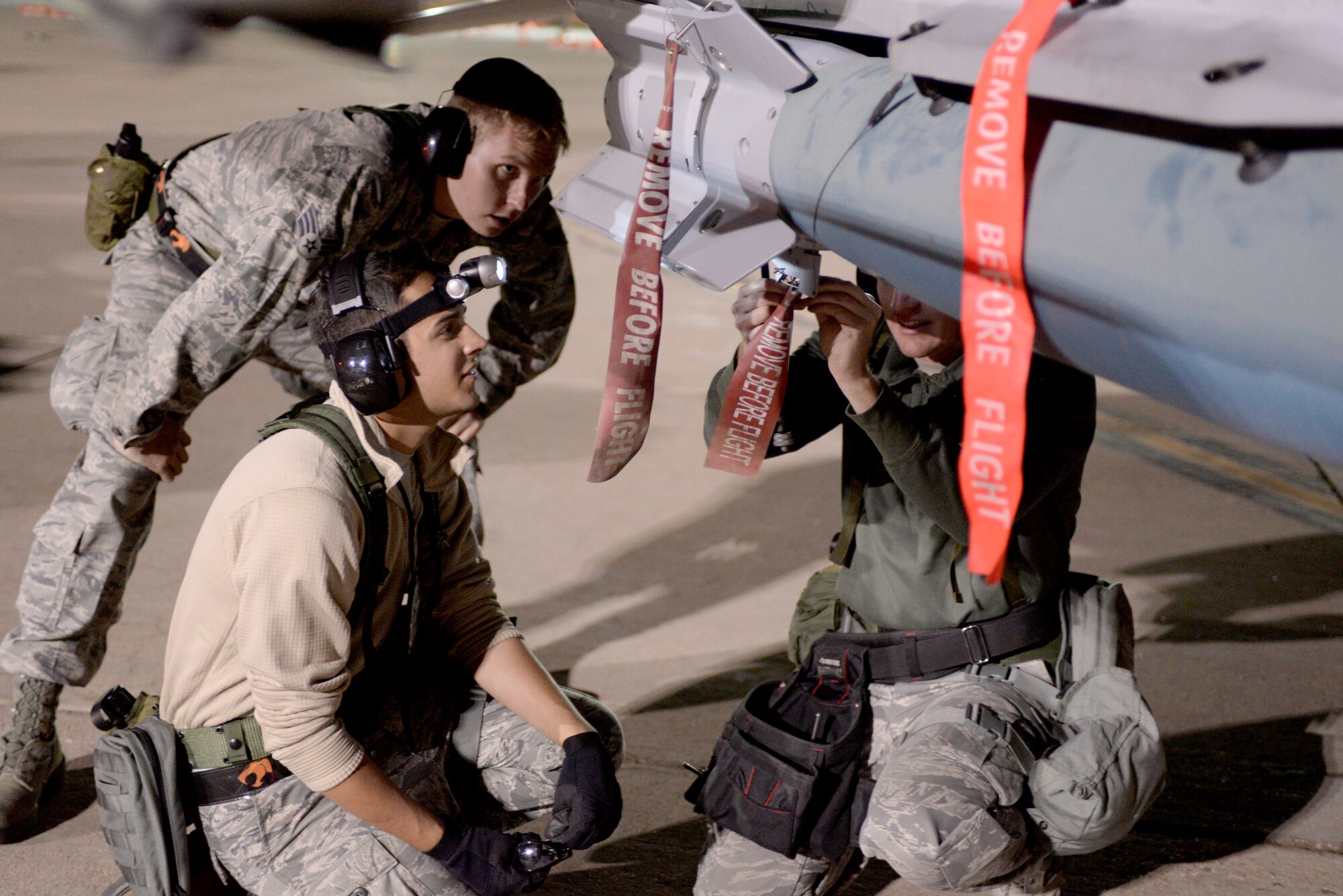 U.S. Air Force Airmen, assigned to 140th Weapons Maintenance Squadron, Colorado Air National Guard, load bombs in preparation for a night flying exercise at Buckley Air Force Base in Aurora, Colo., during the wing wartime readiness inspection Oct. 16, 2015. Weapons have been responsible for loading and unloading bombs, guns and any other weapons on the aircraft. (U.S. Air Force photo by Senior Airman Bobbie Reynolds)