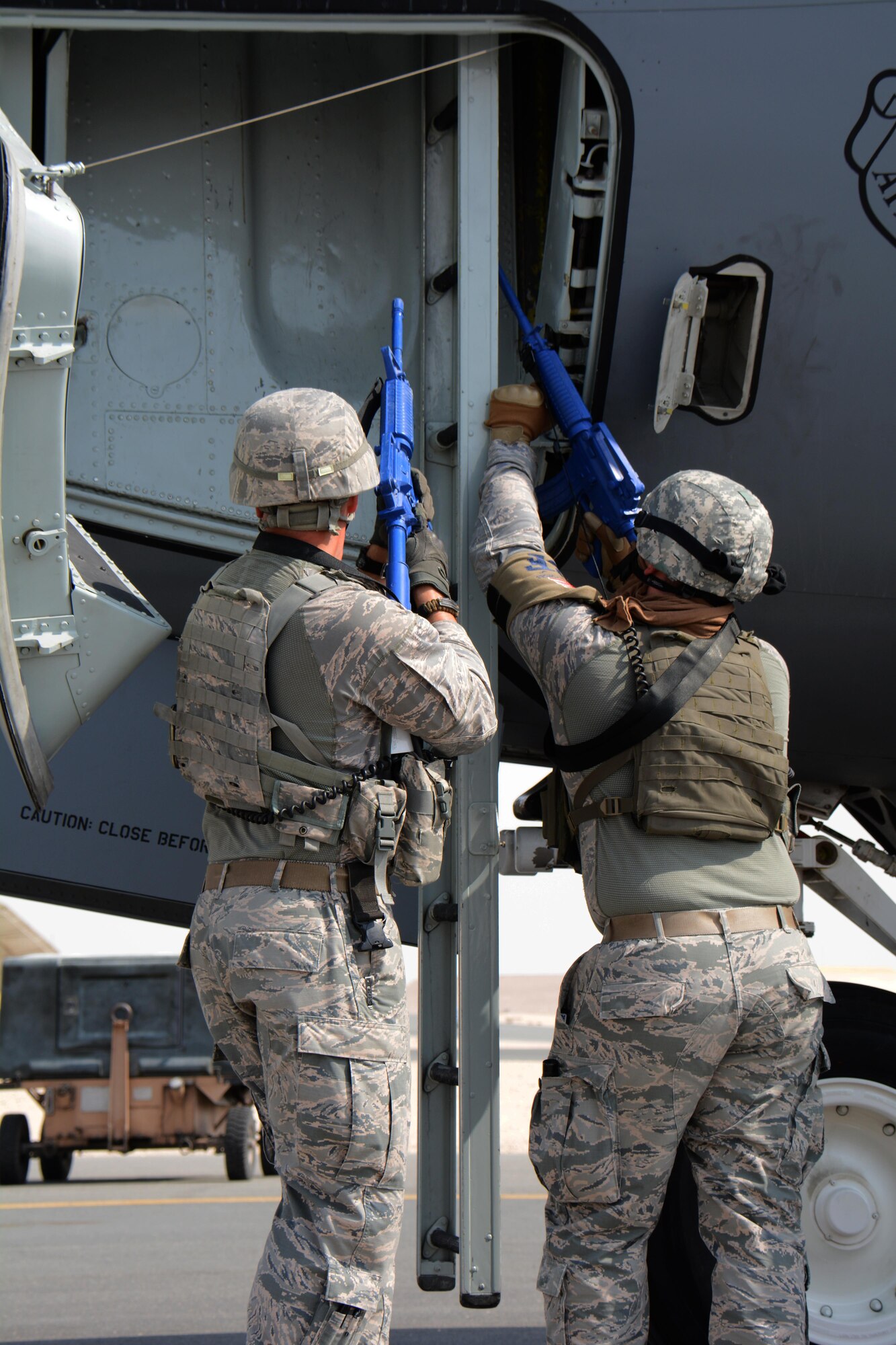 379th Expeditionary Security Forces Squadron airmen responding to a force protection exercise move in to challenge a suspected aircraft hijacker at Al Udeid Air Base, Qatar Nov. 12. The training exercise featured U.S. airmen and Qatar Emir Air Force airmen working together to apprehend the suspect and retake the plane. (U.S. Air Force photo by Tech. Sgt. James Hodgman)