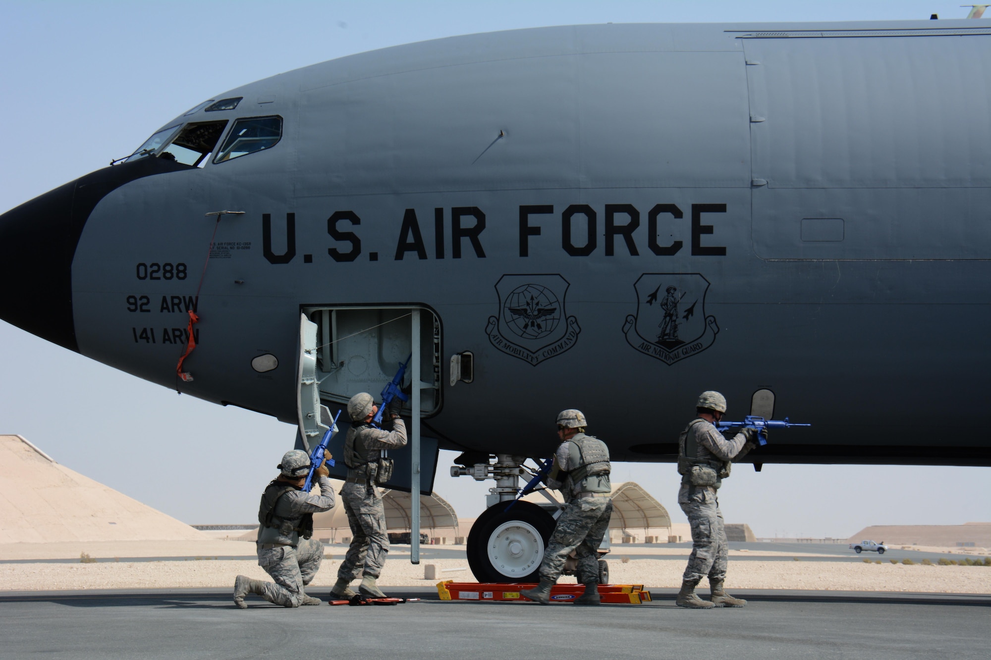 Airmen assigned to the 379th Expeditionary Security Forces Squadron respond to a force protection exercise at Al Udeid Air Base, Qatar Nov. 12. During the exercise, U.S. Air Force security forces airmen joined Qatar Emir Air Force airmen, as they secured the exercise site and apprehended the suspect who was attempting to hijack a KC-135 Stratotanker. (U.S. Air Force photo by Tech. Sgt. James Hodgman)