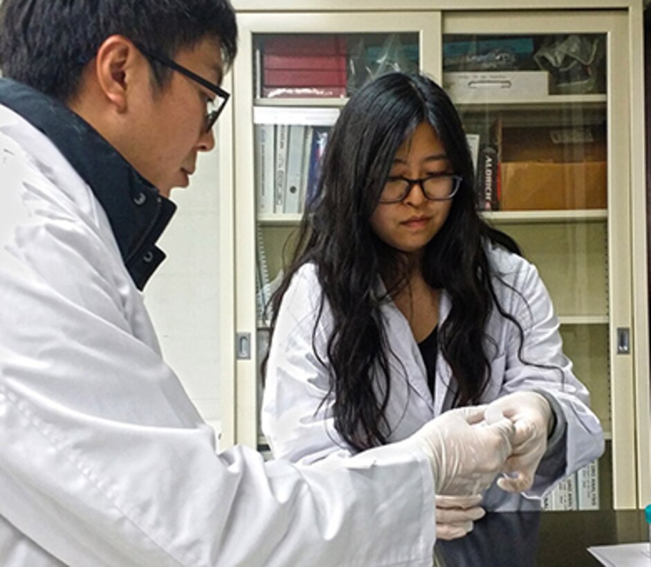 Mr. Yo-Sep Song demonstrates a field testing kit to student Kelly Wun. The field testing kit is used for screening of petroleum contaminated soil. Ms. Wun is a senior at Seoul American High School, and shadowed Far East District staff members on Nov. 5, 2015 to learn more about what they do. Mr. Song is a chemist in the Geotechnical and Environmental Engineering Branch in the Far East District of the U.S. Army Corps of Engineers.  (Photo courtesy of Dr. Son-Chu Chon, U.S. Army Corps of Engineers)