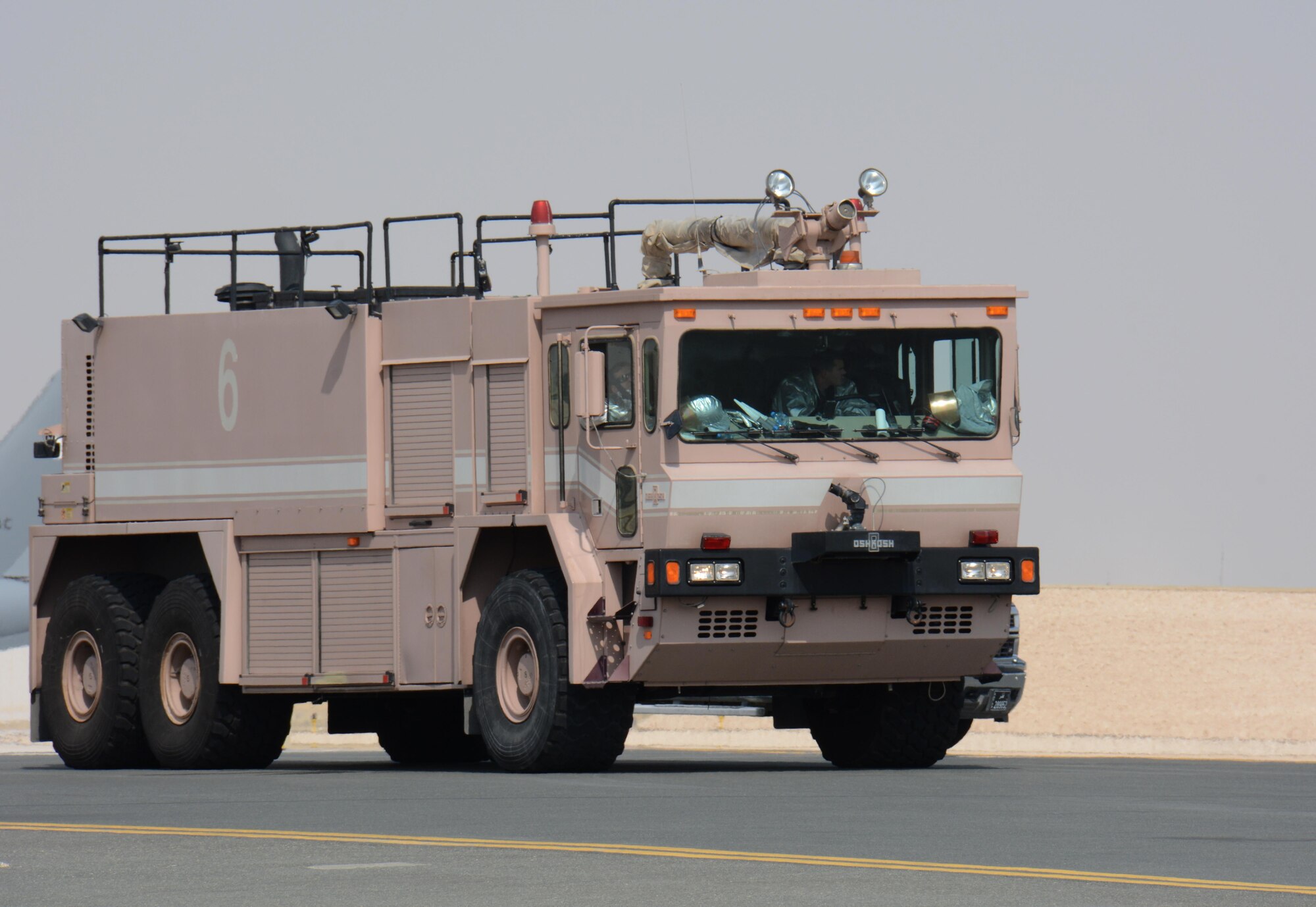 379th Expeditionary Civil Engineer Squadron firefighters respond to a force protection exercise at Al Udeid Air Base, Qatar Nov. 12. The exercise featured an attempted aircraft hijacking. U.S. airmen joined airmen from the Qatar Emir Air Force in the exercise. (U.S. Air Force photo by Tech. Sgt. James Hodgman)
