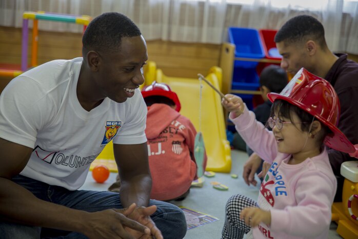 1st Lt. Donovan Holloway, air intelligence officer with Marine Fighter Attack Squadron 242, plays with a Japanese orphan during a Single Marine Program volunteer event at Kaihoku-En Children’s Home in Hofu City, Yamaguchi Prefecture, Japan, Nov. 14, 2015. The children interacted and built relationships with the 18 service members during the visit. The visit afforded the children the opportunity to meet new people and have an afternoon filled with interaction.