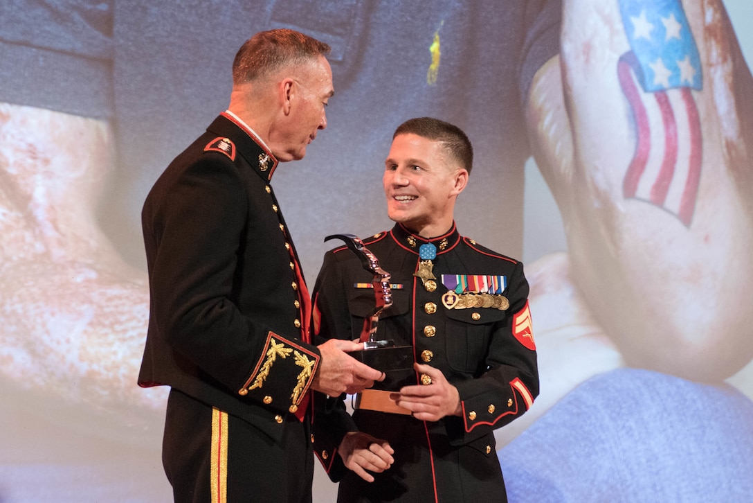 Marine Corps Gen. Joseph F. Dunford Jr., left, chairman of the Joint Chiefs of Staff, presents the Portrait of a Nation Prize to Cpl. Kyle Carpenter at the National Portrait Gallery in Washington, D.C., Nov. 15, 2015. DoD photo by D. Myles Cullen
