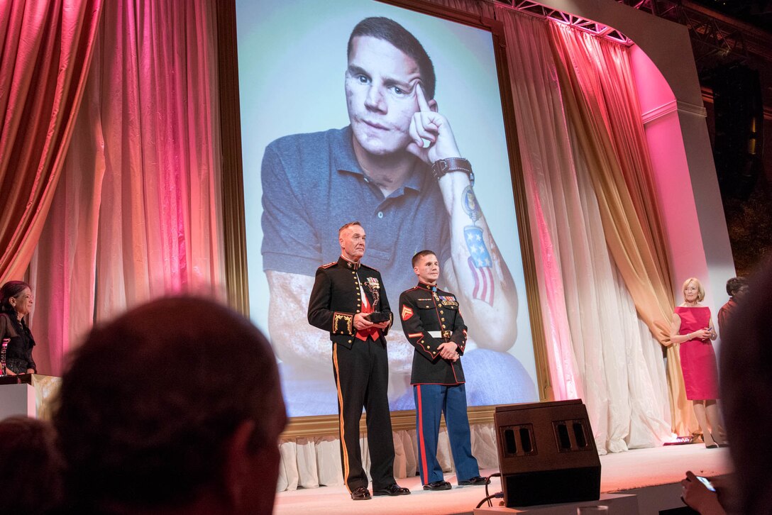Marine Corps Gen. Joseph F. Dunford Jr., chairman of the Joint Chiefs of Staff, stands with Cpl. Kyle Carpenter before presenting him with the Portrait of a Nation Prize at the National Portrait Gallery in Washington, D.C., Nov. 15, 2015. DoD photo by D. Myles Cullen