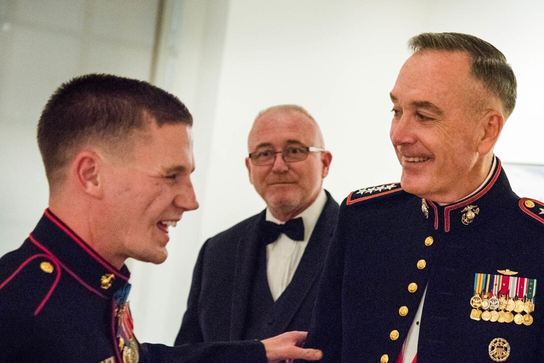 Marine Corps Gen. Joseph F. Dunford Jr., right, chairman of the Joint Chiefs of Staff, shares a light moment with Cpl. Kyle Carpenter at the National Portrait Gallery in Washington, D.C., Nov. 15, 2015. Dunford presented Carpenter, a Medal of Honor recipient, with the Portrait of a Nation Prize in recognition of his bravery and patriotism. DoD photo by D. Myles Cullen