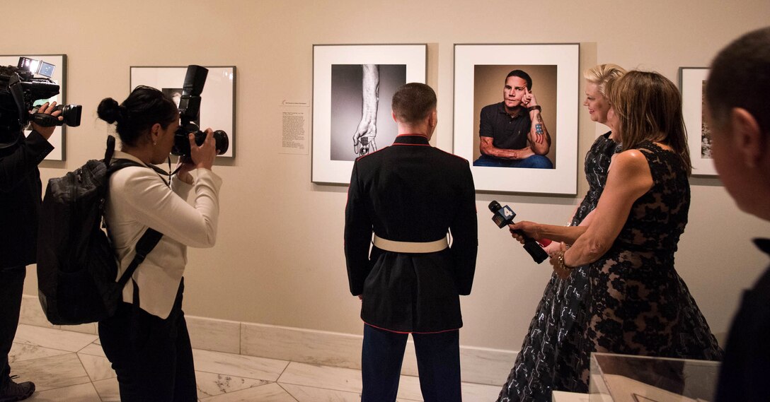 Marine Corps Cpl. Kyle Carpenter observes his portrait while curators and reporters await his reaction at the National Portrait Gallery in Washington, D.C., Nov. 15, 2015. DoD photo by D. Myles Cullen