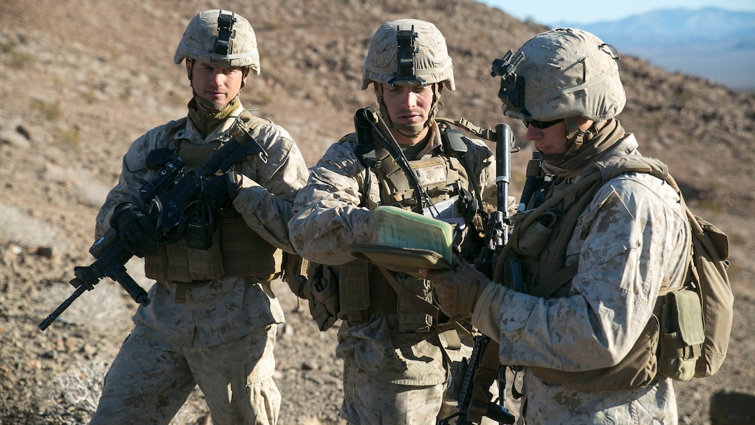 Corporal Jason Trent, right, a squad leader with Golf Company, 2nd Battalion, 2nd Marine Regiment briefs his fire plan sketch to 1stLt. Ryan Ayer, center, during the Battalion Assault Course as part of Integrated Training Exercise 1-16 at Marine Air Ground Combat Center, Twentynine Palms, California, Nov. 11, 2015. The BAC calls on support from the air, ground and logistics combat elements, utilizing the full capabilities of the Marine Air-Ground Task Force to complete the training objectives. 